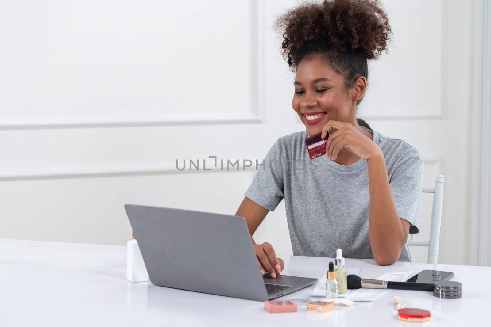 Young happy woman buy product by online shopping at home while ordering items from the internet with credit card online payment system protected by crucial cyber security from online store platform