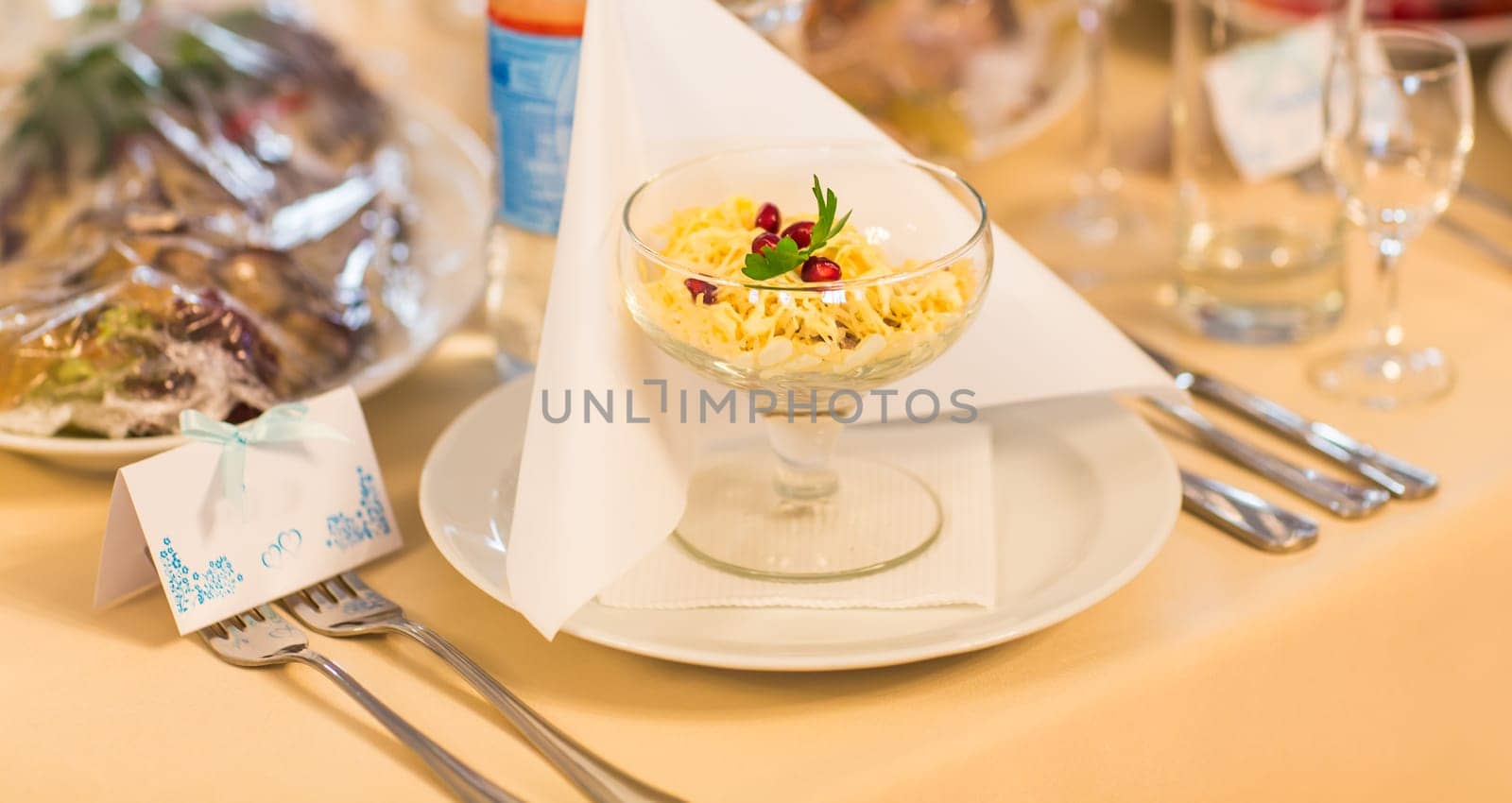 Served for a banquet table. Wine glasses with napkins, plate and salads. by Satura86