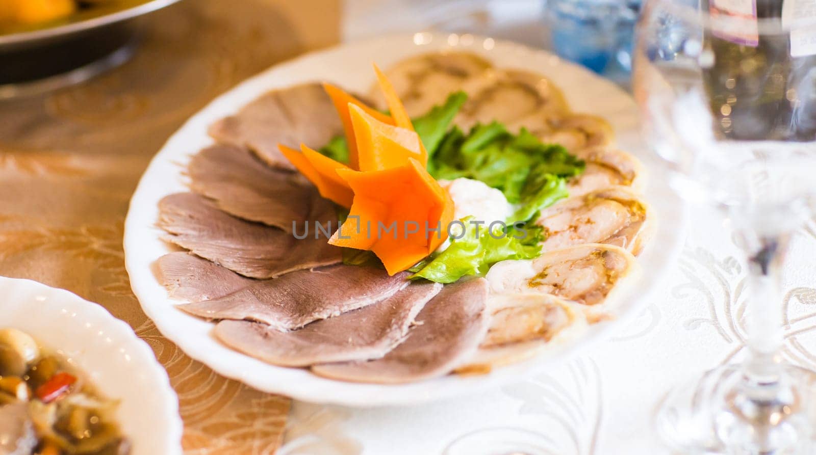 Slices of boiled beef tongue on a festive table