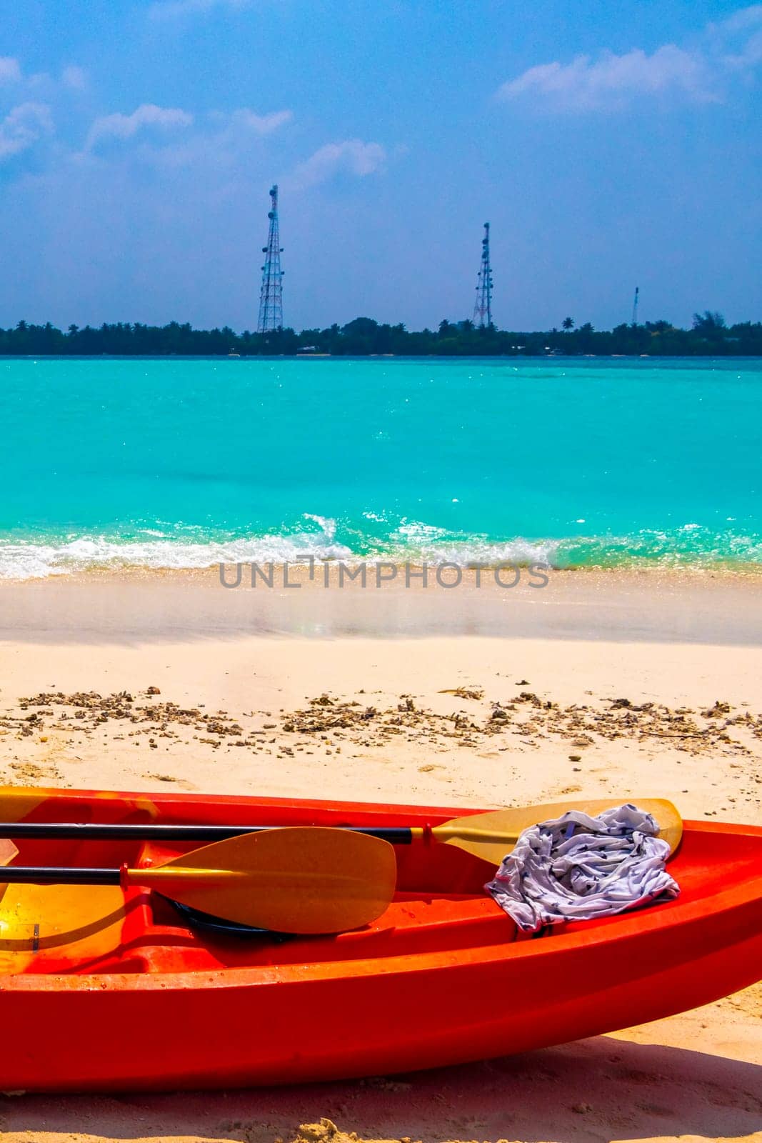 Canoe boat on the white sand and turquoise sea on Rasdhoo island in Rasdhoo Atoll Maldives.