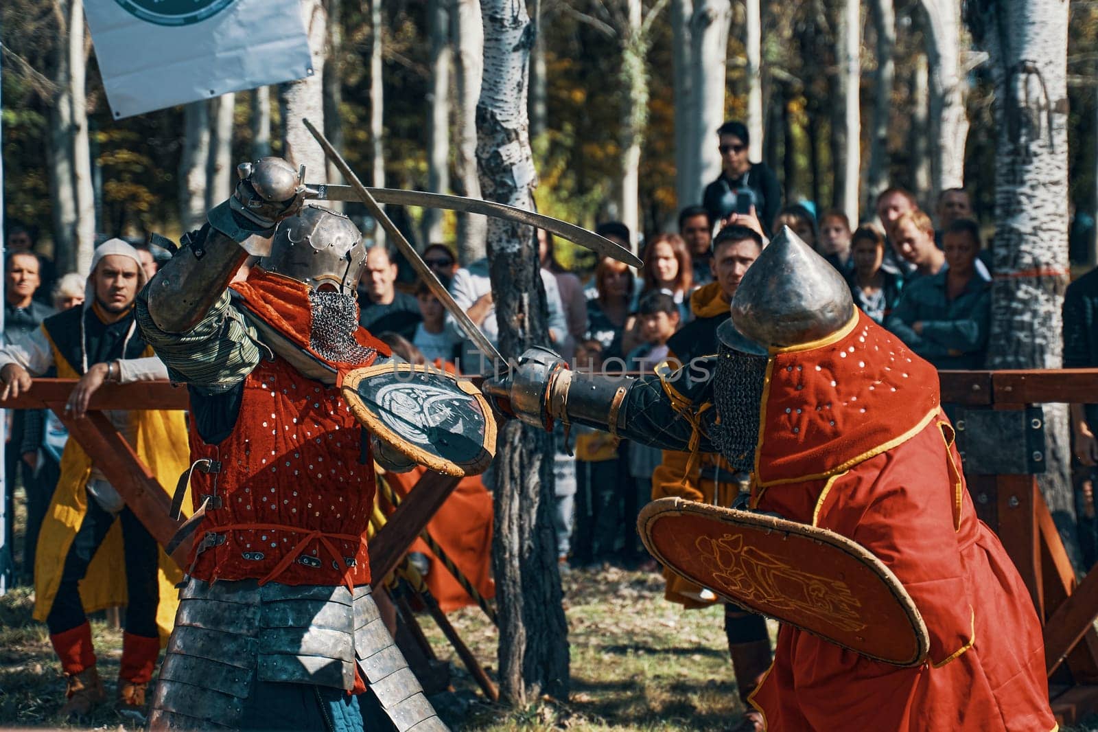 Bishkek, Kyrgyzstan-October 13, 2019. Reconstruction of knightly battles. Simulation of medieval battles during the festival of historical clubs. Two red-robed knights are fighting with swords.
