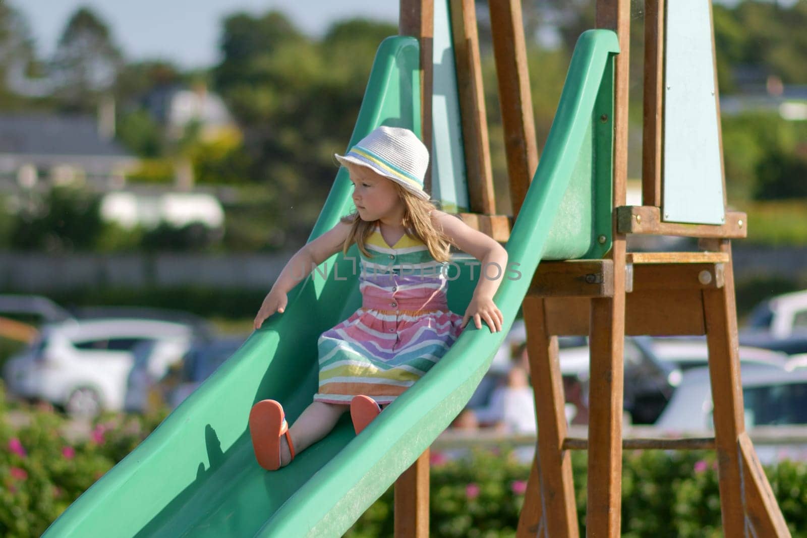 Girl of three years old sliding outdoor Playground