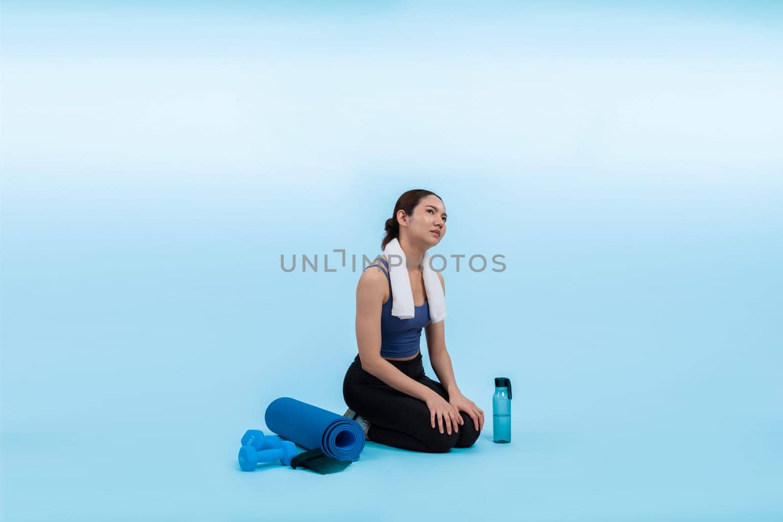 Athletic and sporty asian woman resting after intensive cardio workout training. Healthy exercising and fit body care lifestyle pursuit in studio shot isolated background. Vigorous