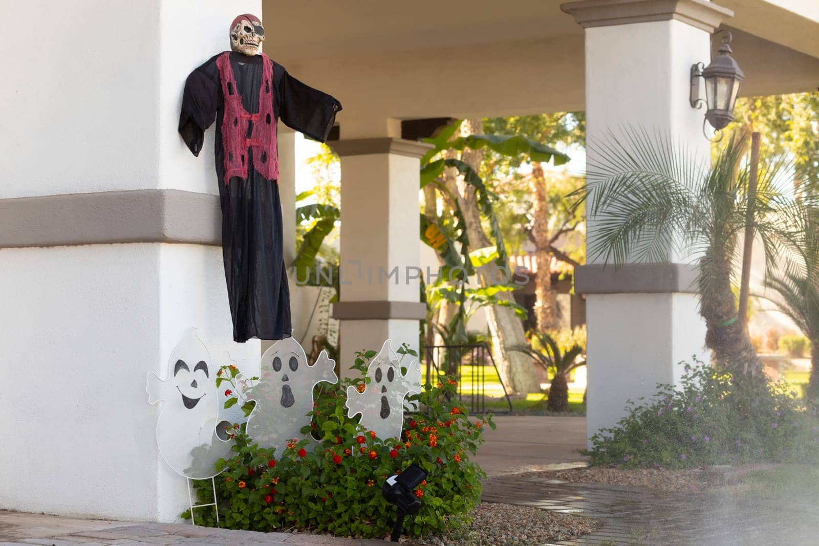 Flying Scary Ghosts with Faces on Wall Are Traditional Attributes Of Halloween. Outdoor Decoration For Halloween Party. Sunny Day. Copy Space For Text. Horizontal Plane. High quality photo