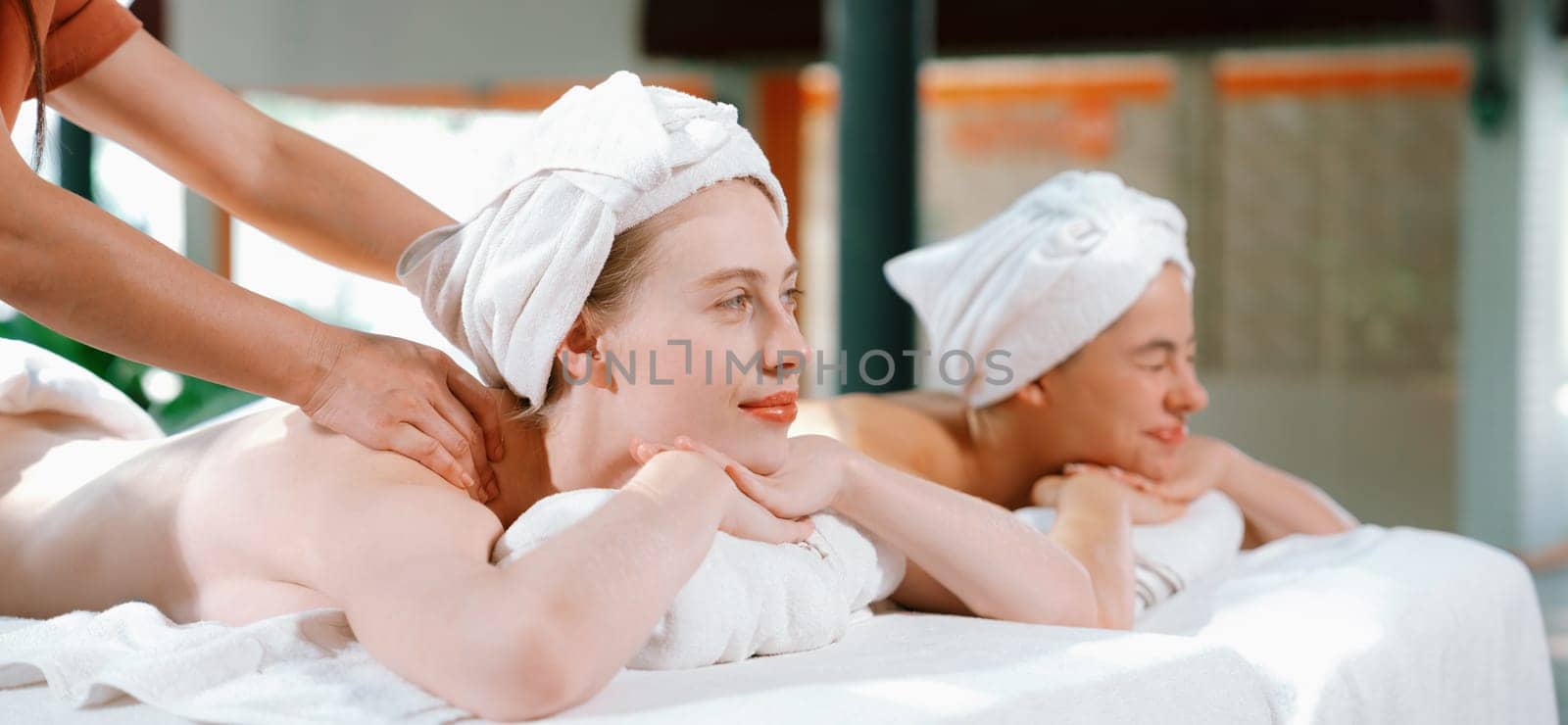 Couple of beautiful woman having back massage at peaceful spa room. Tranquility. by biancoblue