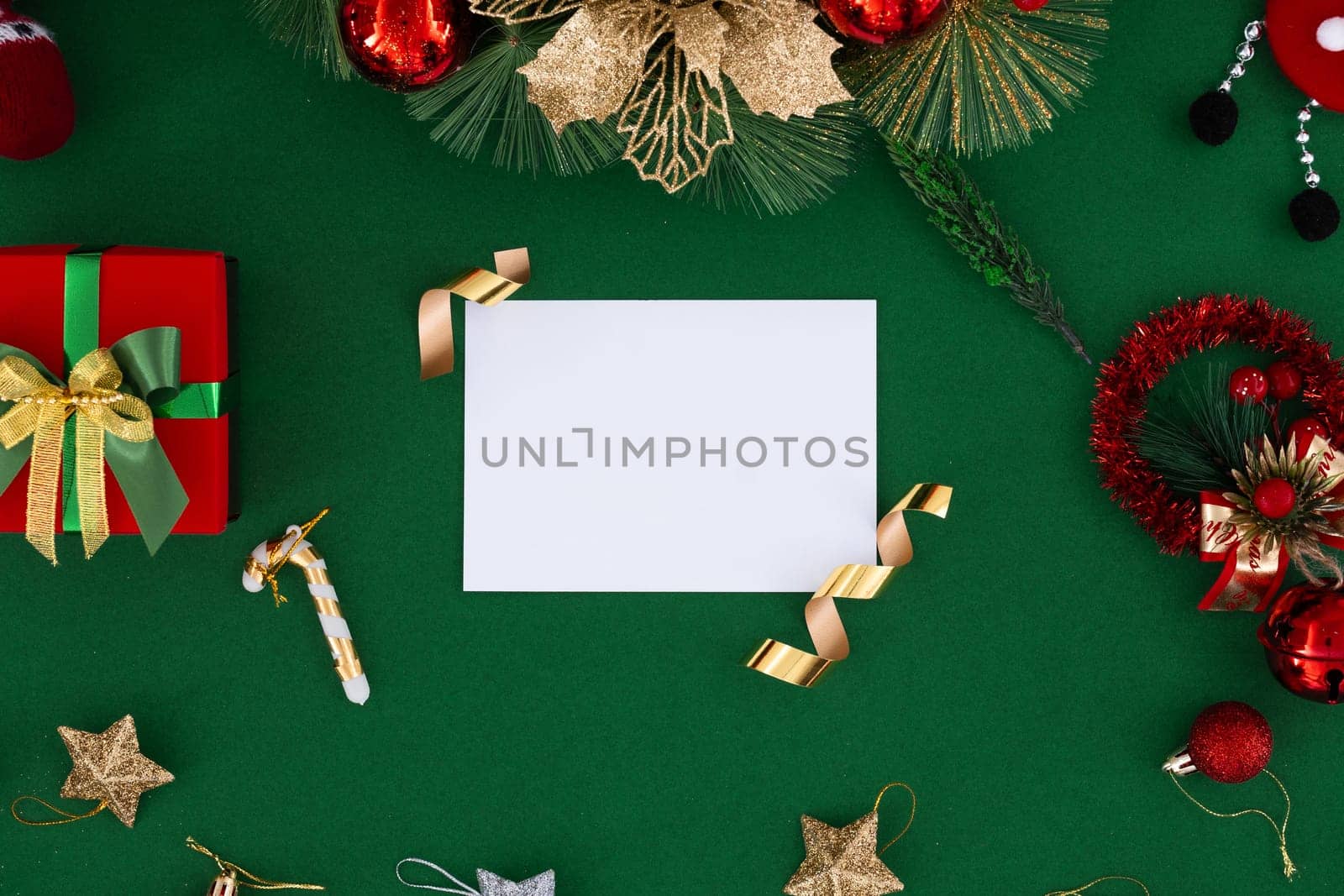 Christmas blank greeting card mock-up scene. Creative layout made of Christmas tree branches with paper card note. Flat lay. Nature New Year concept.