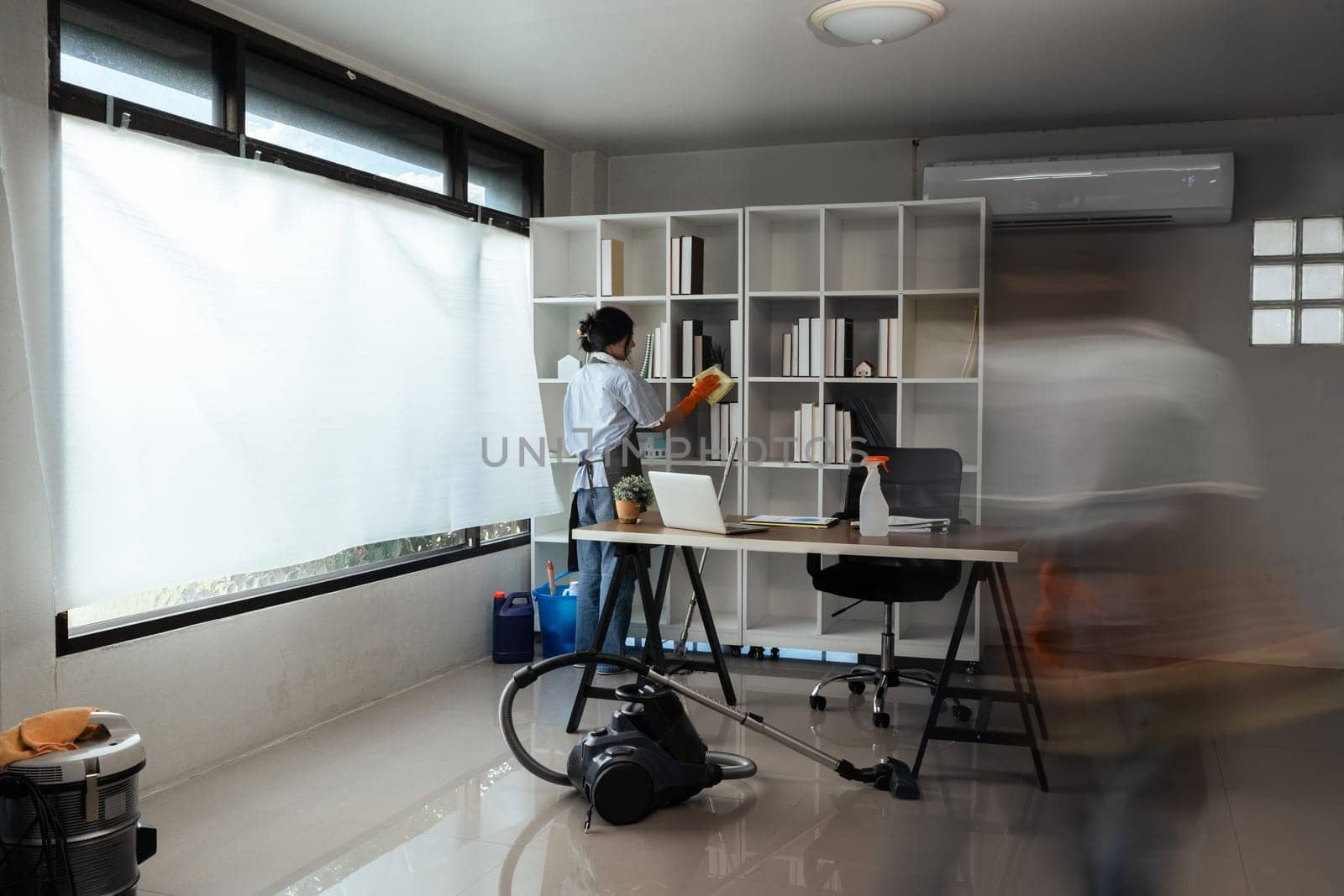 Team of maid housekeeping service cleaning wearing uniform cleaning at office. motion blur.