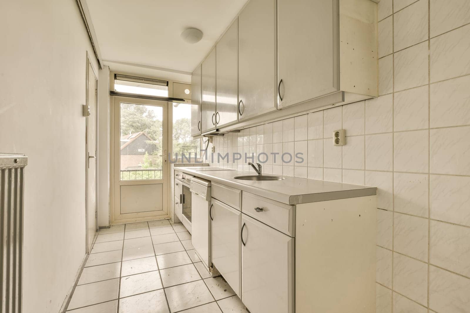 a kitchen with white cabinets and a sink by casamedia