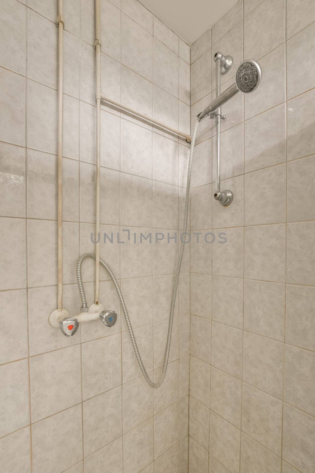 a shower in a tiled bathroom with a shower by casamedia
