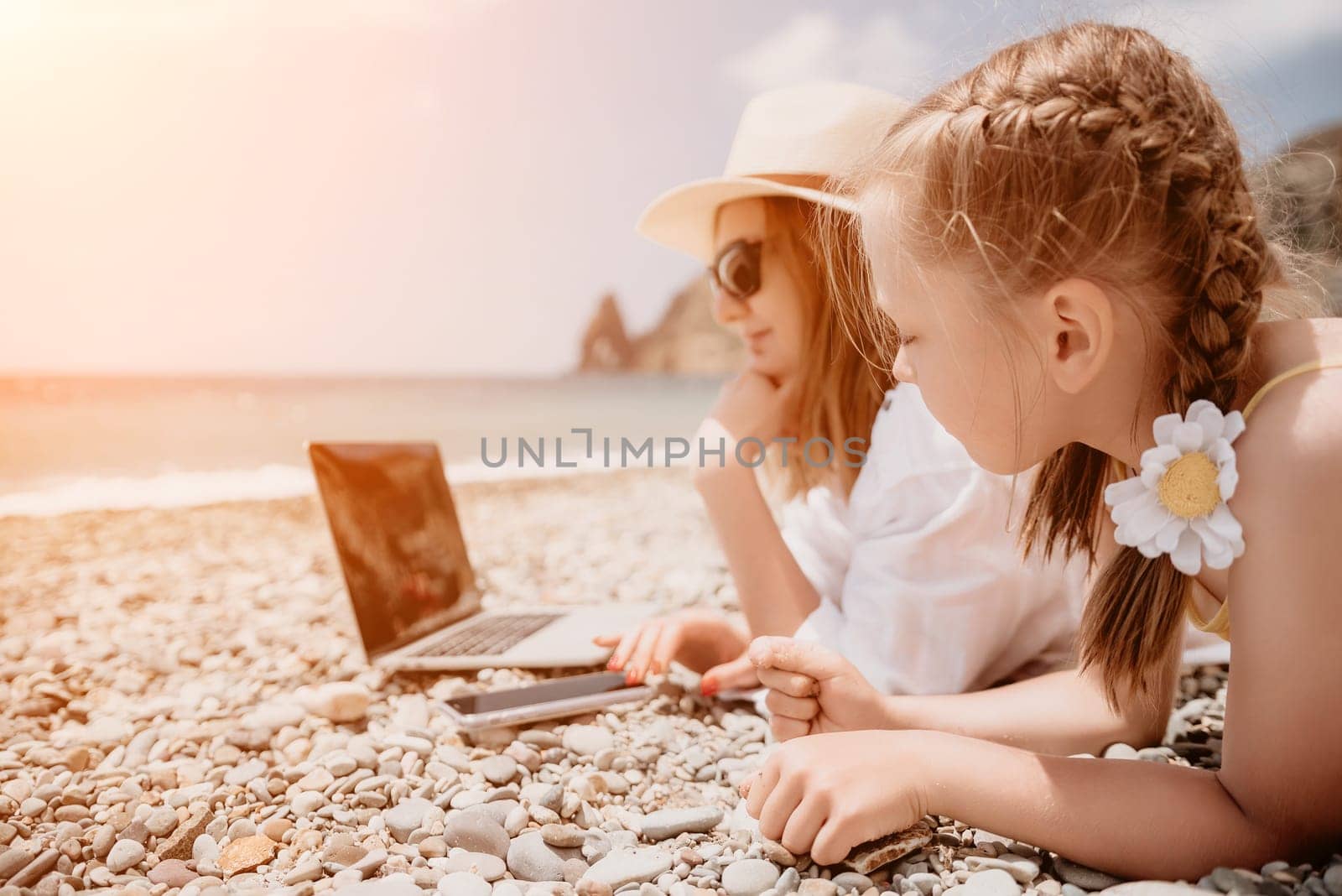 Woman sea laptop. Business woman in yellow hat working on laptop by sea. Close up on hands of pretty lady typing on computer outdoors summer day. Freelance, digital nomad, travel and holidays concept.