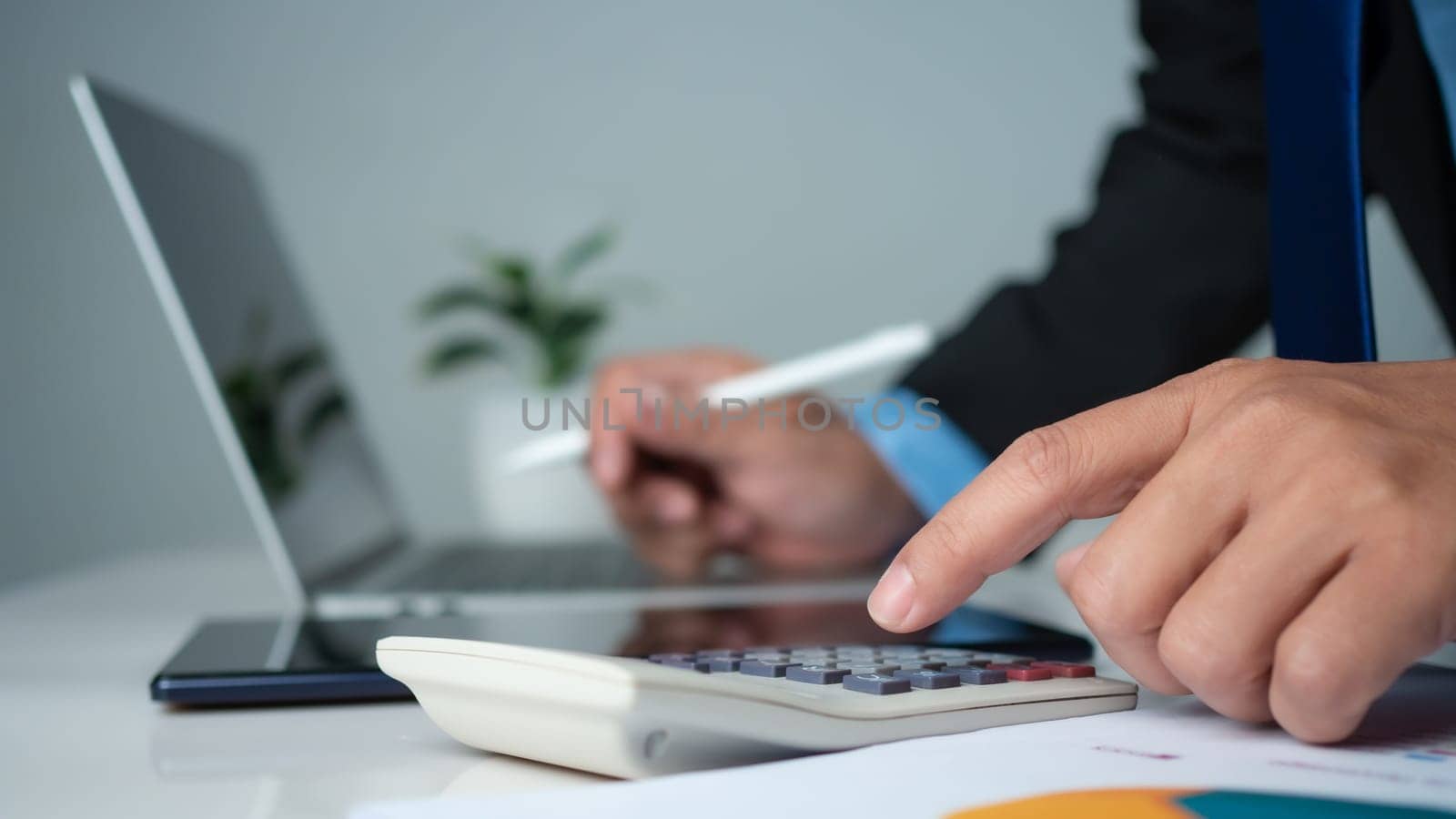 Business accounting concept. Business uses calculator with laptop computer, budget and income concept, sales concept, company accounting management. by Unimages2527