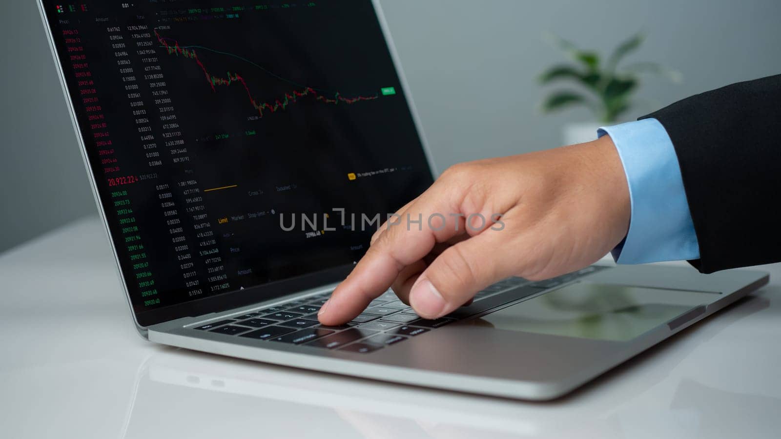 Businessman uses laptop for financial growth, analyzing stock market chart investment strategy, profit trade management and planning technology enhances economic network connections, copy space. by Unimages2527