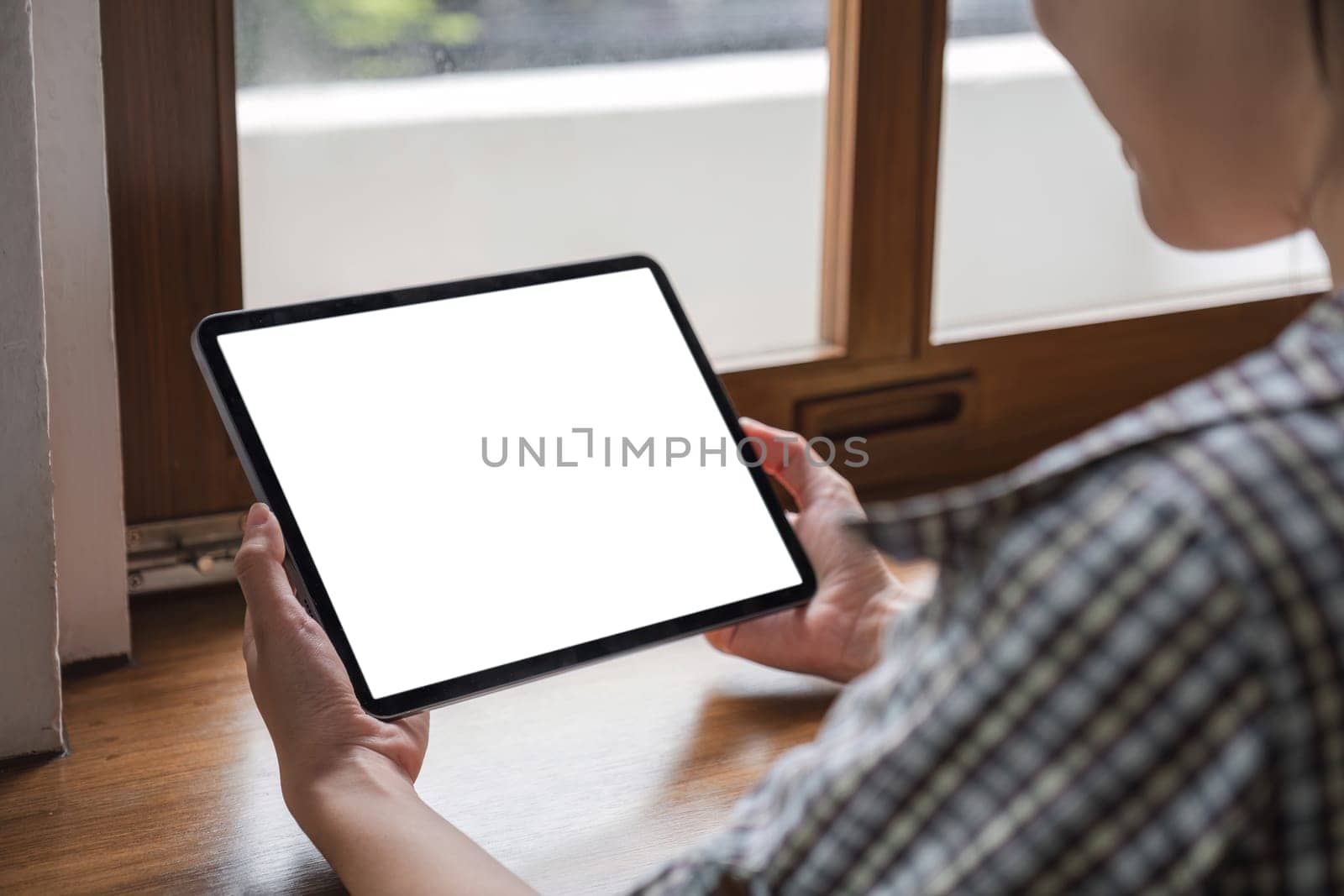 Mockup image of a woman holding digital tablet with blank white desktop screen by wichayada