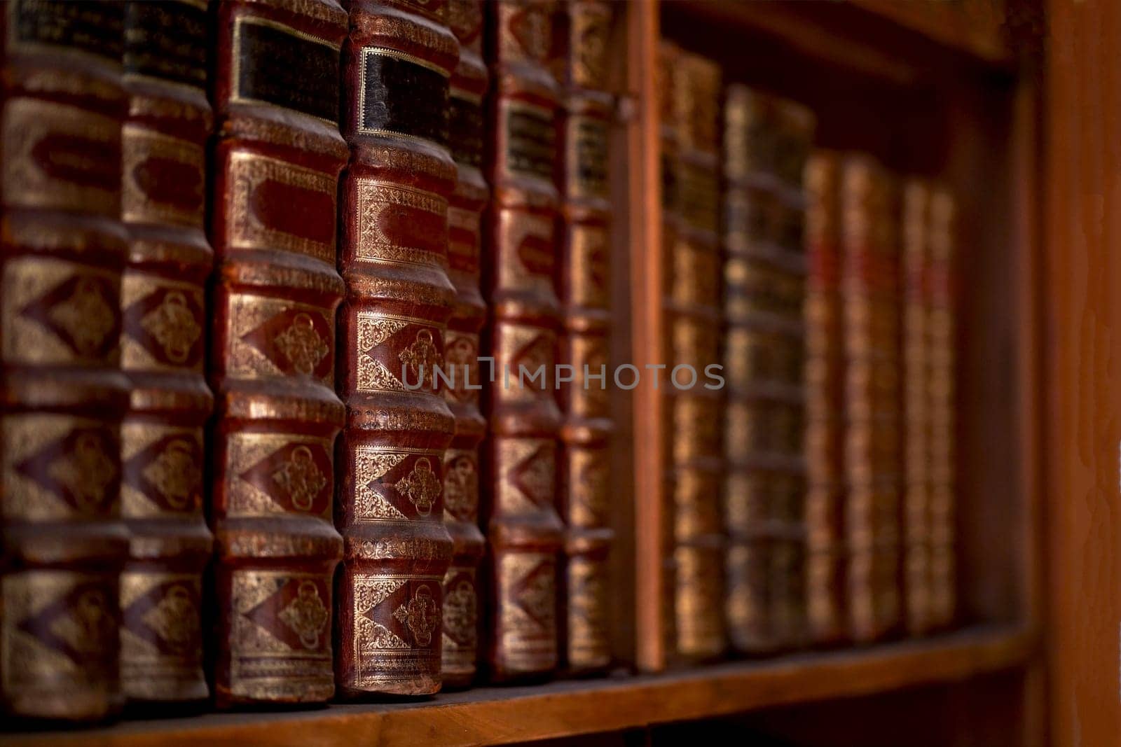 Vienna, Austria, October 2023: Old bookcase with the leather-bound book covers in State Hall of Austrian National Library by aprilphoto
