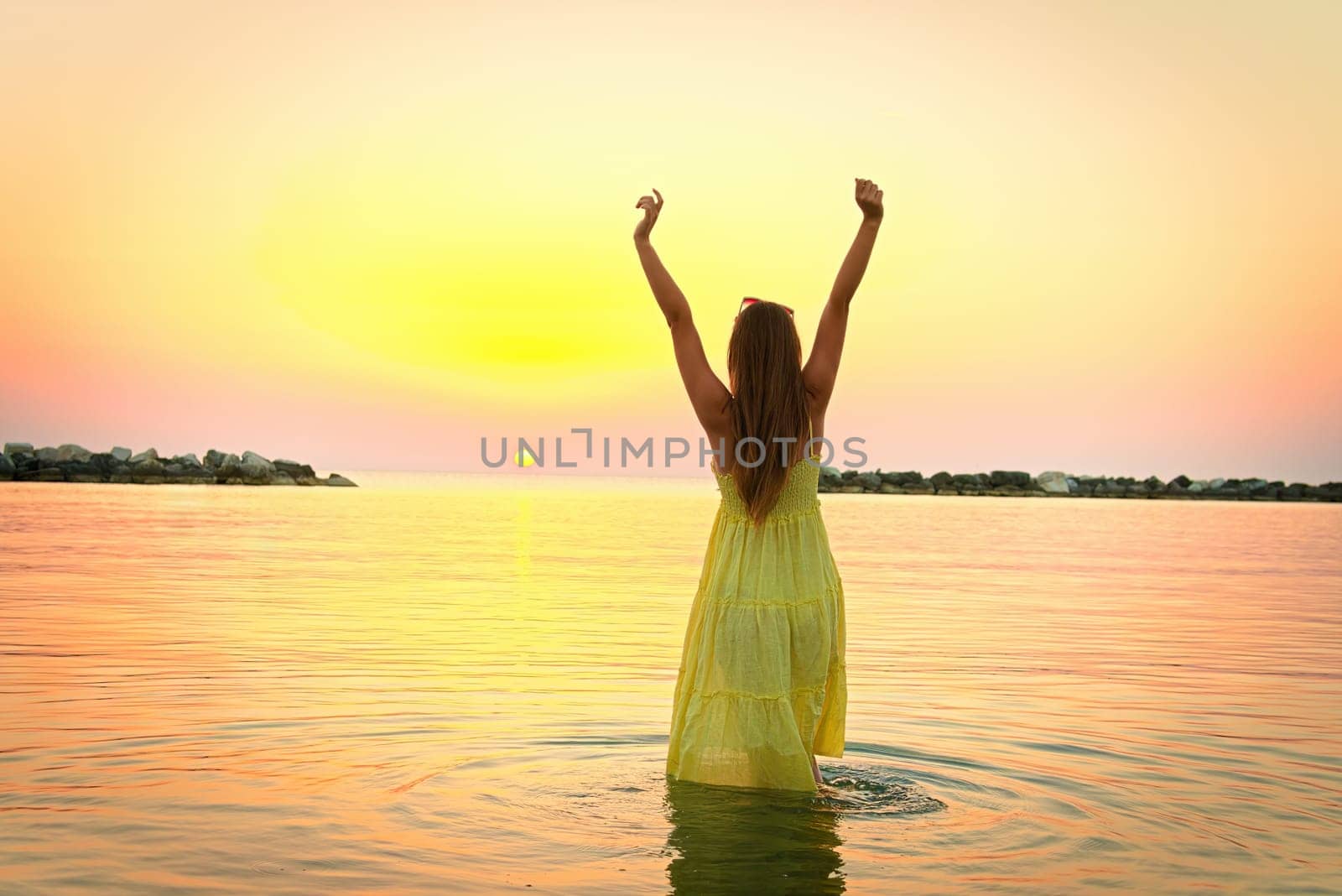 beautiful girl in the water at sunrise by AliaksandrFilimonau