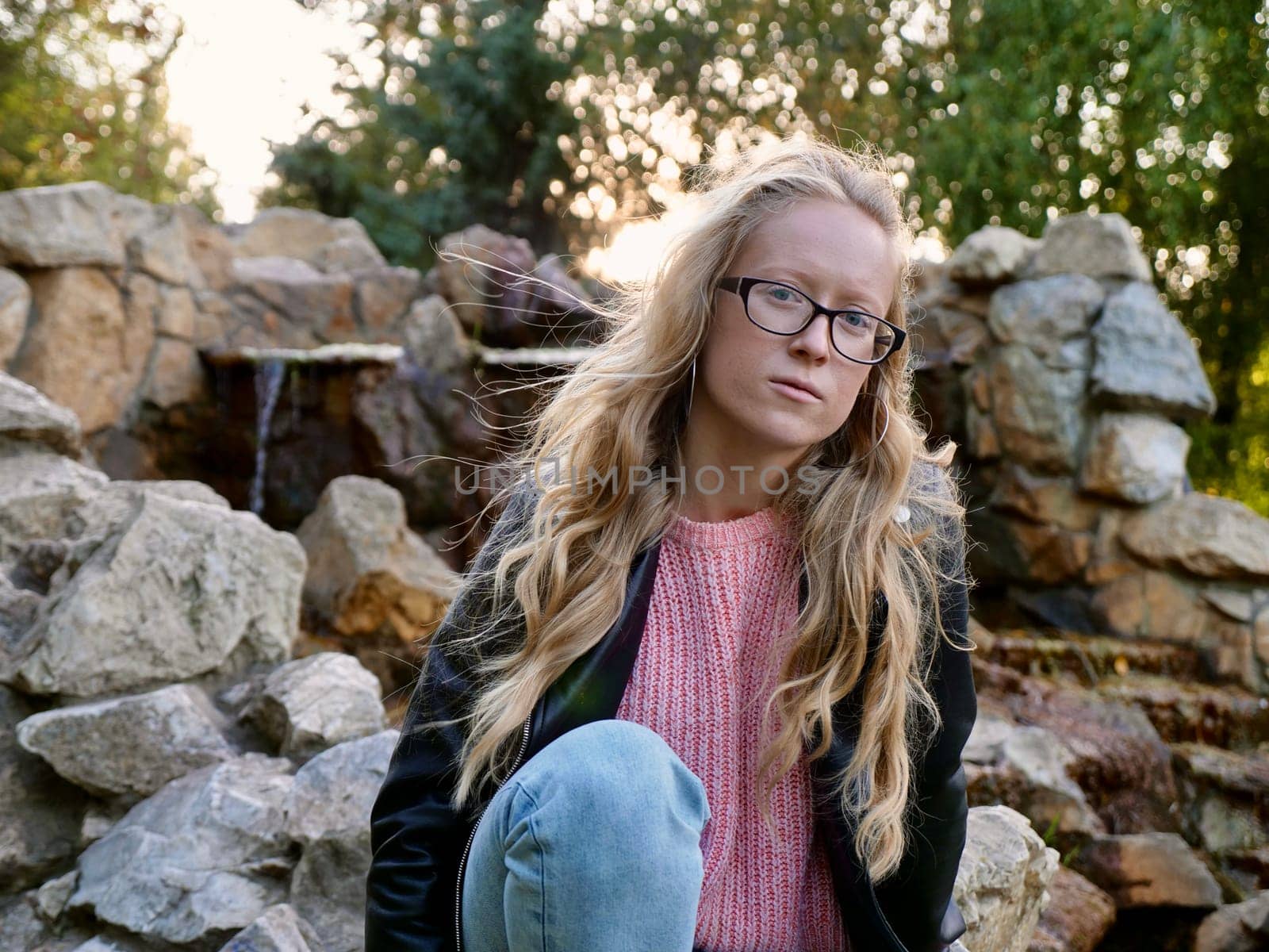 Woman Albinos Sitting Outdoors on stone in park by OksanaFedorchuk