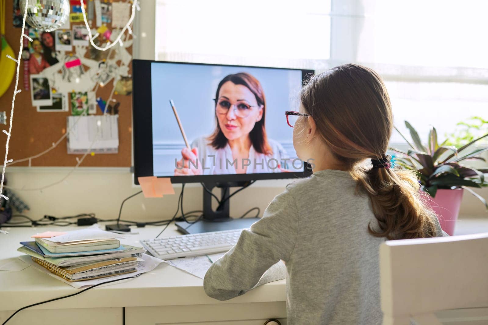 Child girl studying at home online using computer by VH-studio