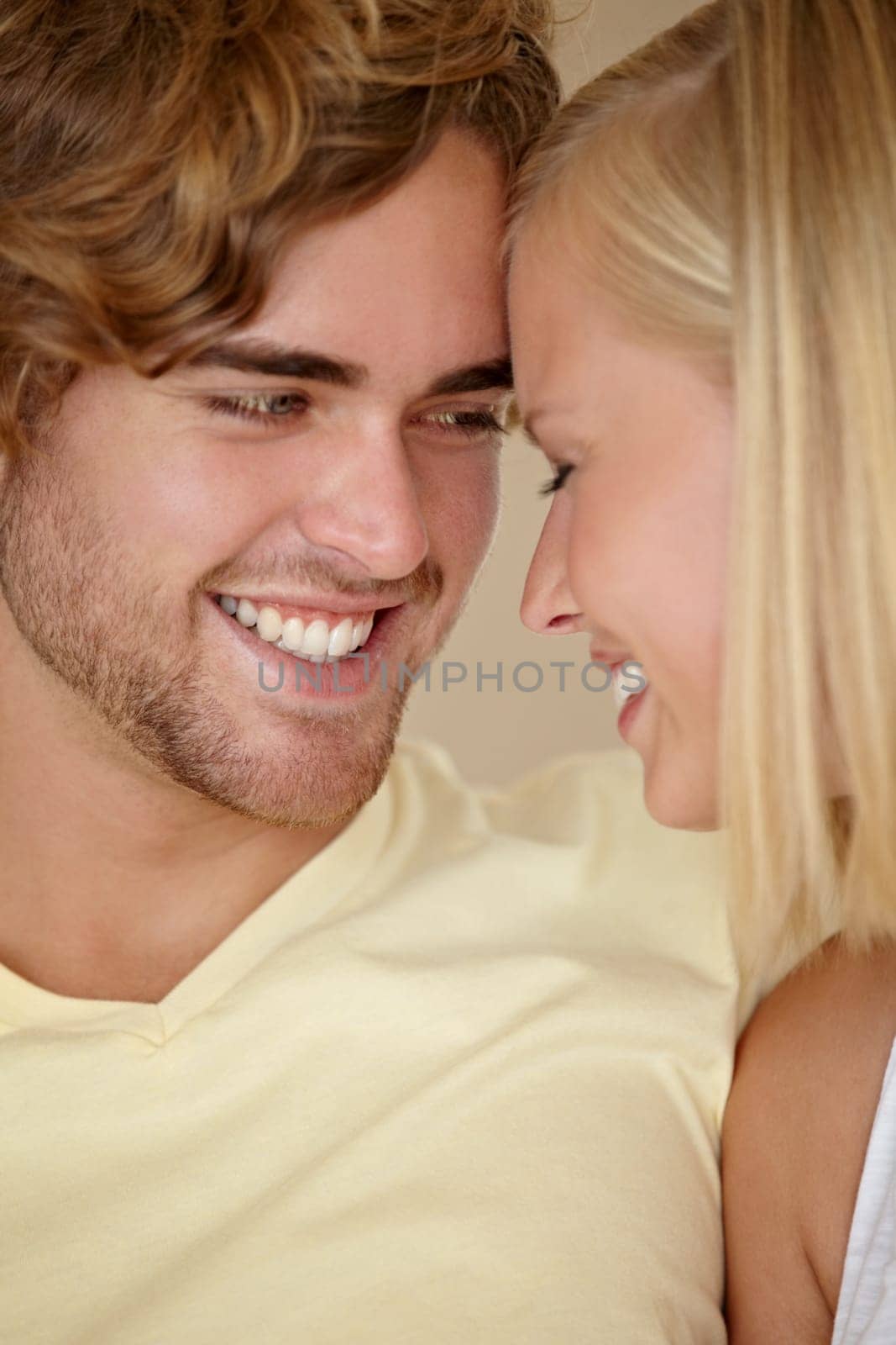 Face, love and relax with a young couple closeup in their home together for romance or bonding. Smile, happy or dating with a man and woman in their apartment to relax during a weekend break.