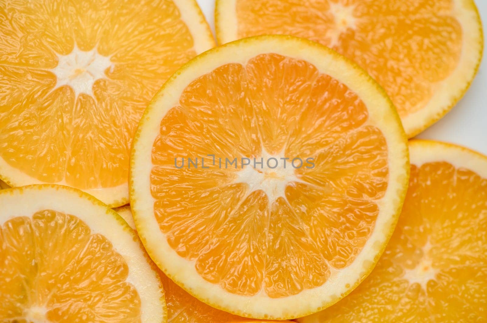 sliced ​​orange laid out on the table as a food background by Mixa74