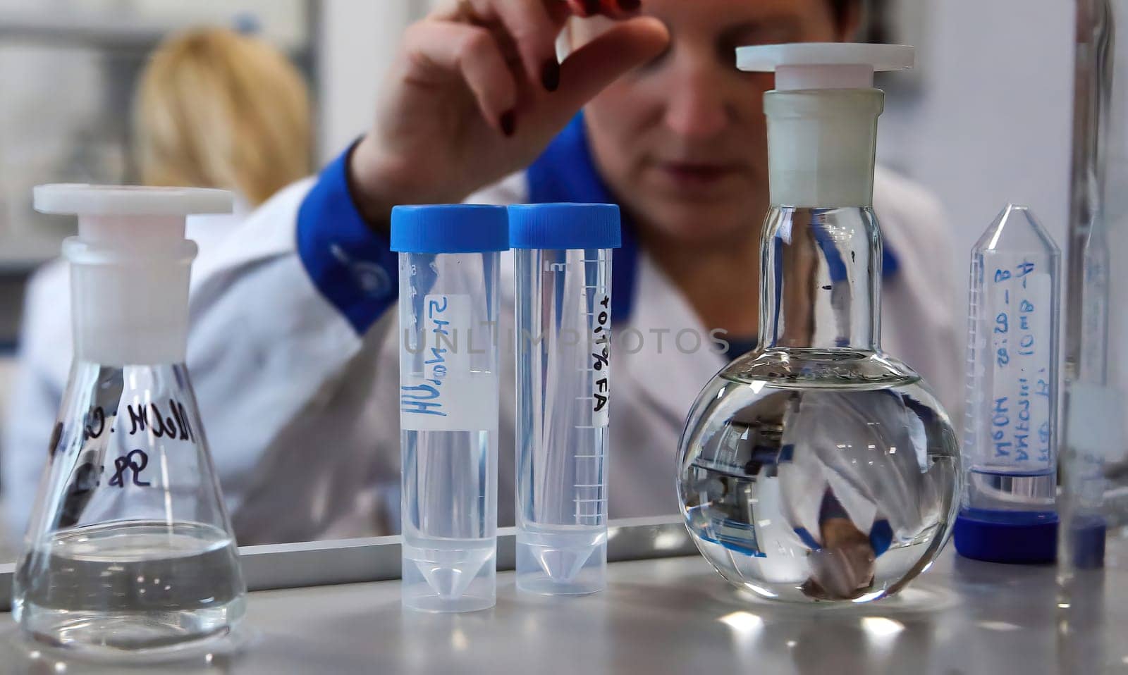 The doctor takes a test tube with liquid, close-up. Work in a chemical laboratory. Laboratory analysis