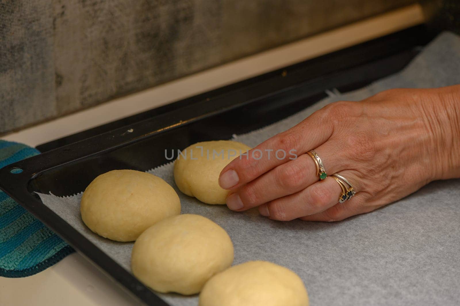 woman placing buns on a baking sheet 3 by Mixa74