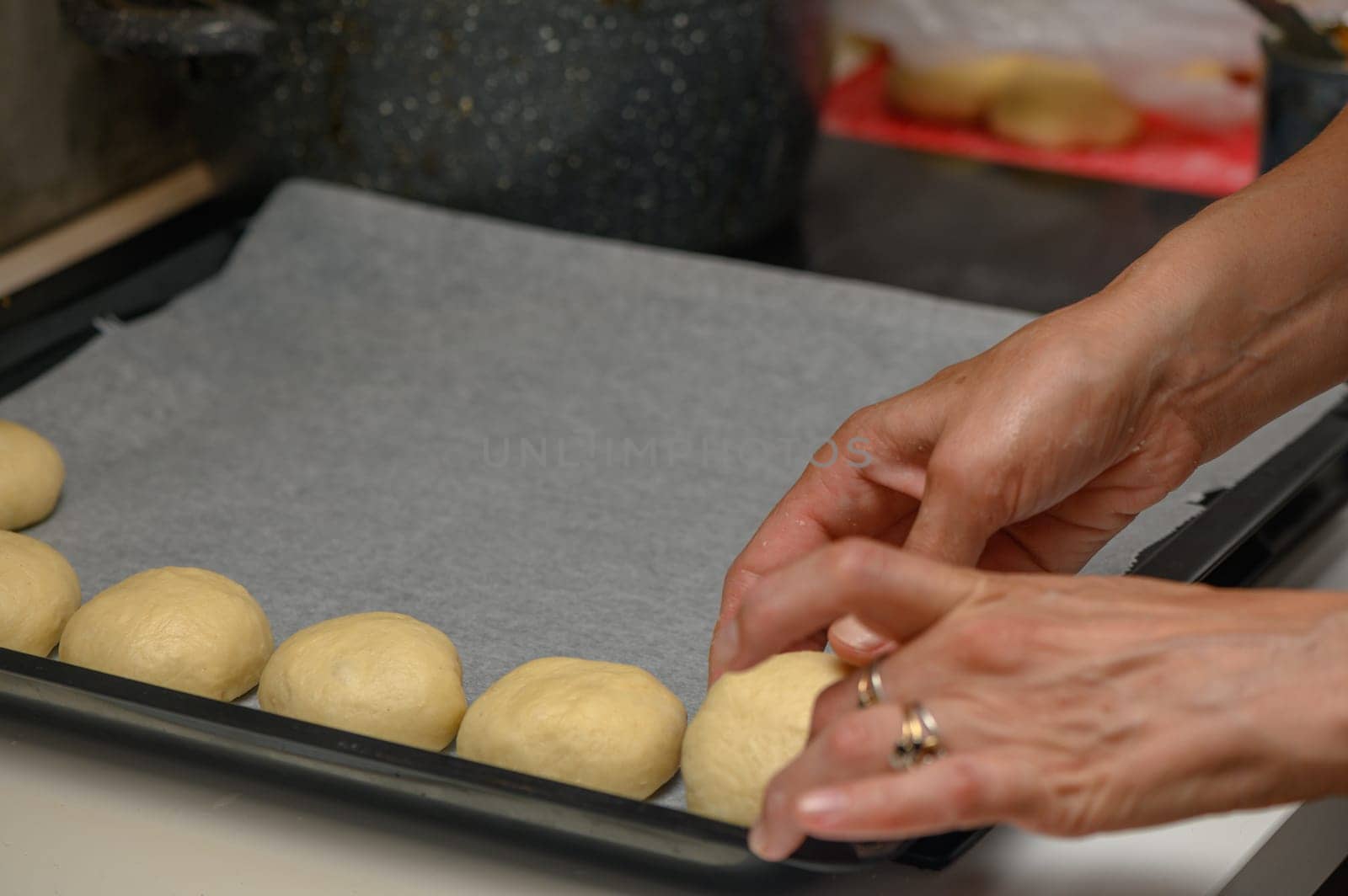 woman placing buns on a baking sheet 1 by Mixa74