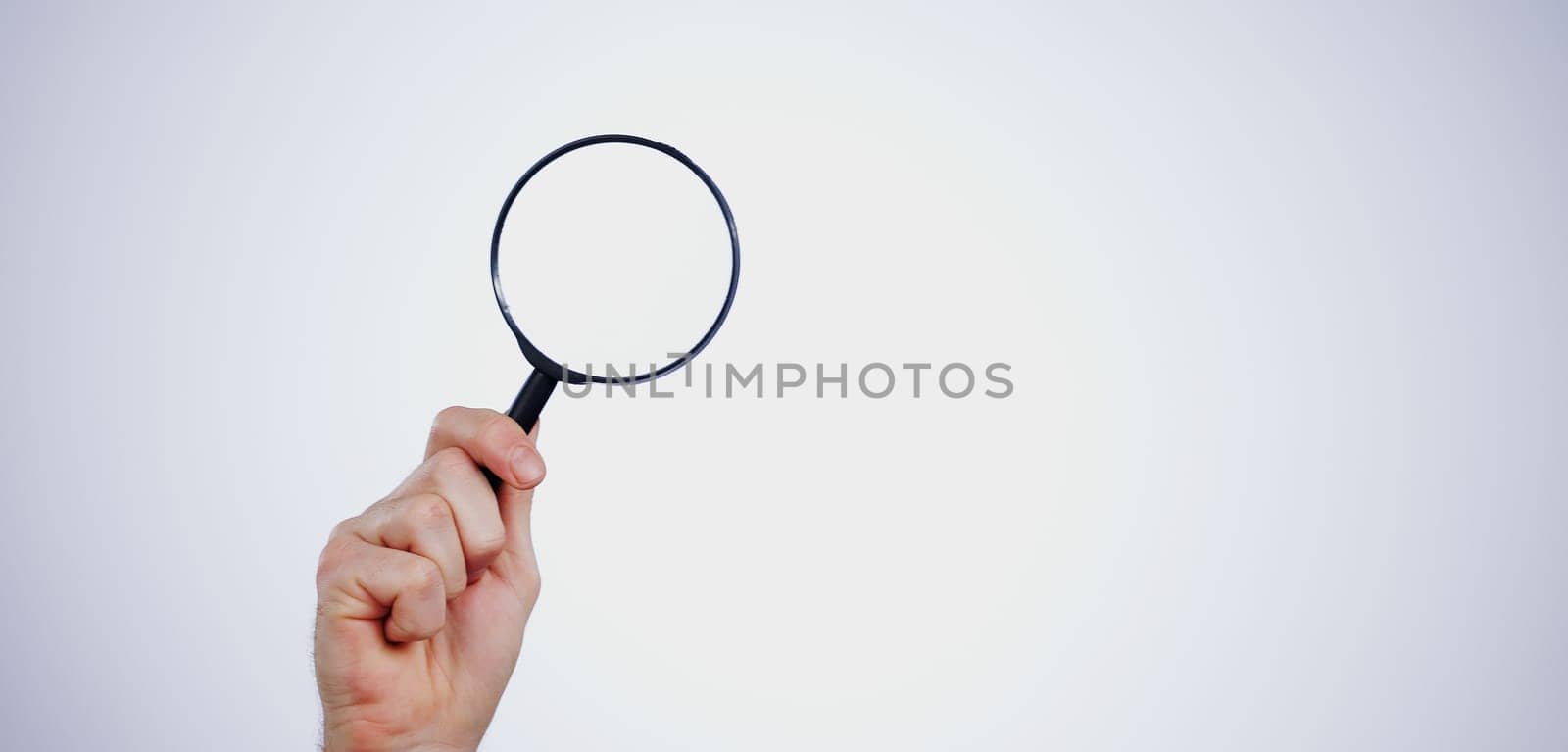 Magnifying glass searching for deals, hand and investigation, search or study with mockup space on white background. Knowledge, source and spy person with analysis, research and reading with problem by YuriArcurs
