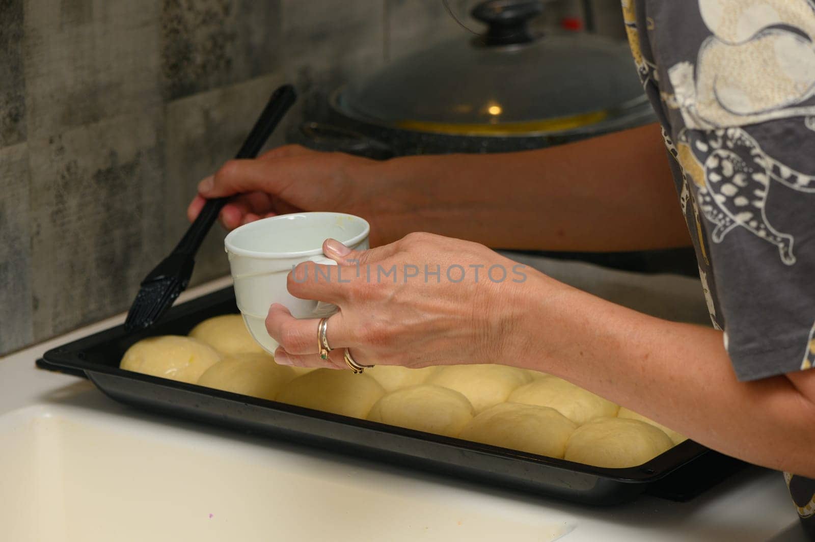 woman greases buns in the kitchen 7