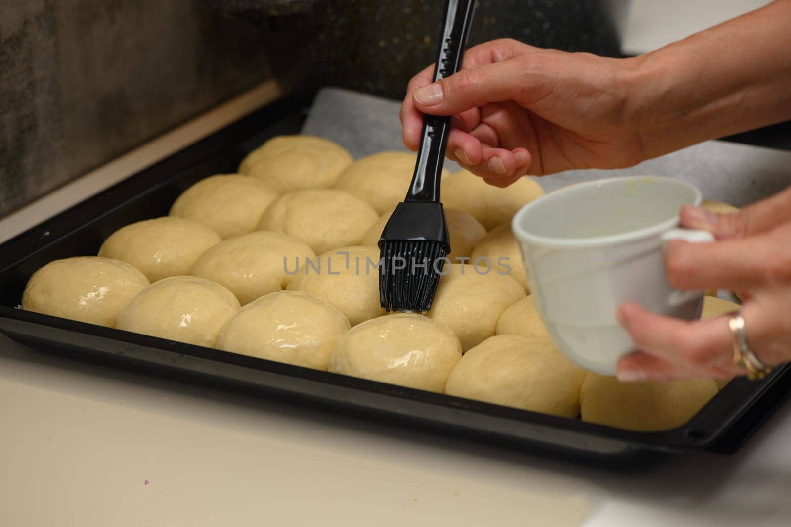 woman greases buns in the kitchen 5