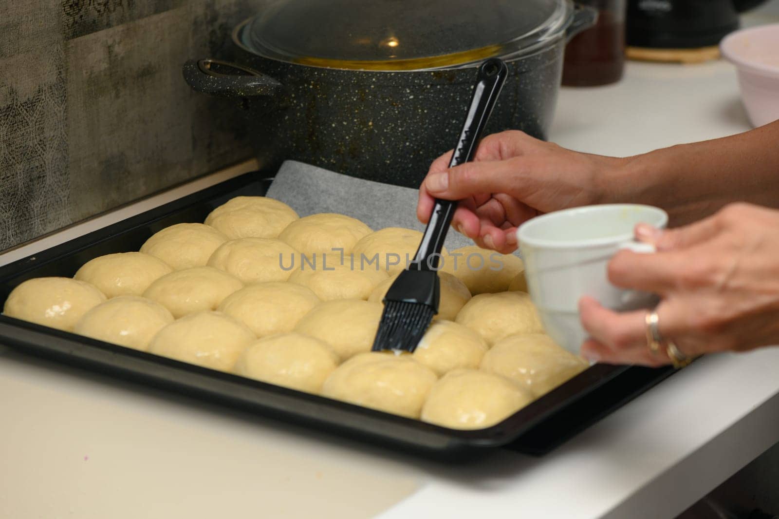 woman greases buns in the kitchen 4