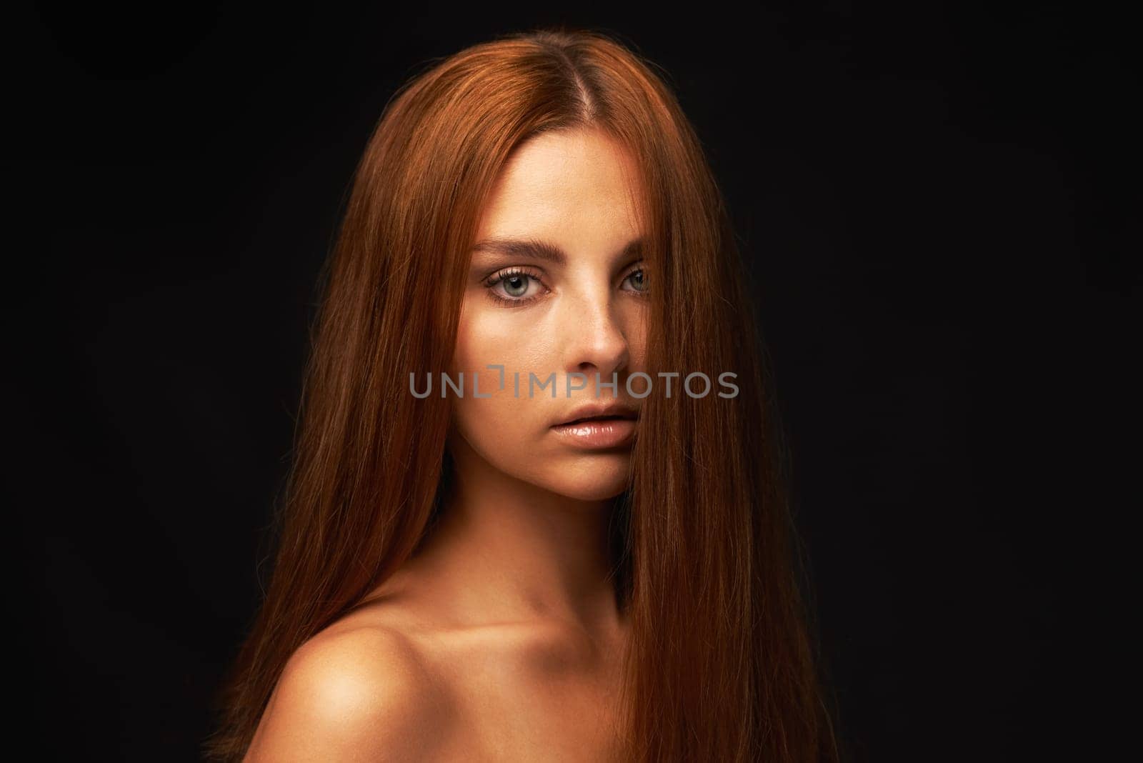 Hair care, portrait or model with beauty, skincare or results for glow, shine or collagen in studio. Black background, face or serious woman with cosmetics for treatment, healthy texture or growth by YuriArcurs