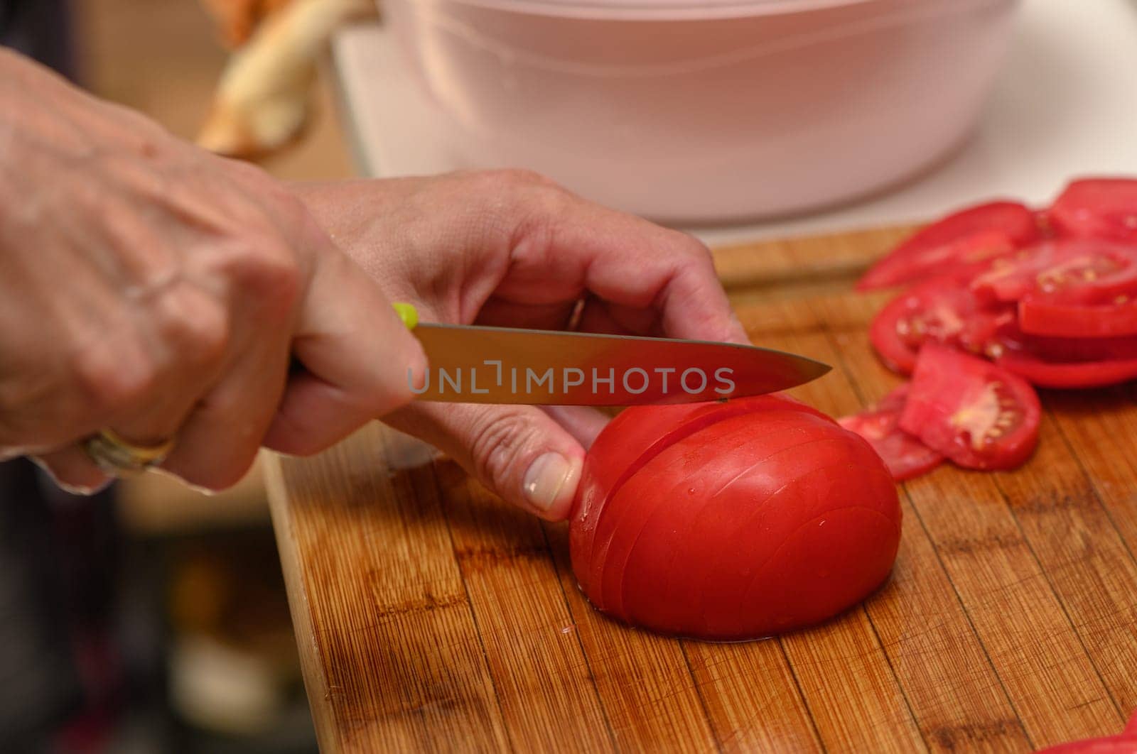 woman cutting tomato on kitchen board 3 by Mixa74