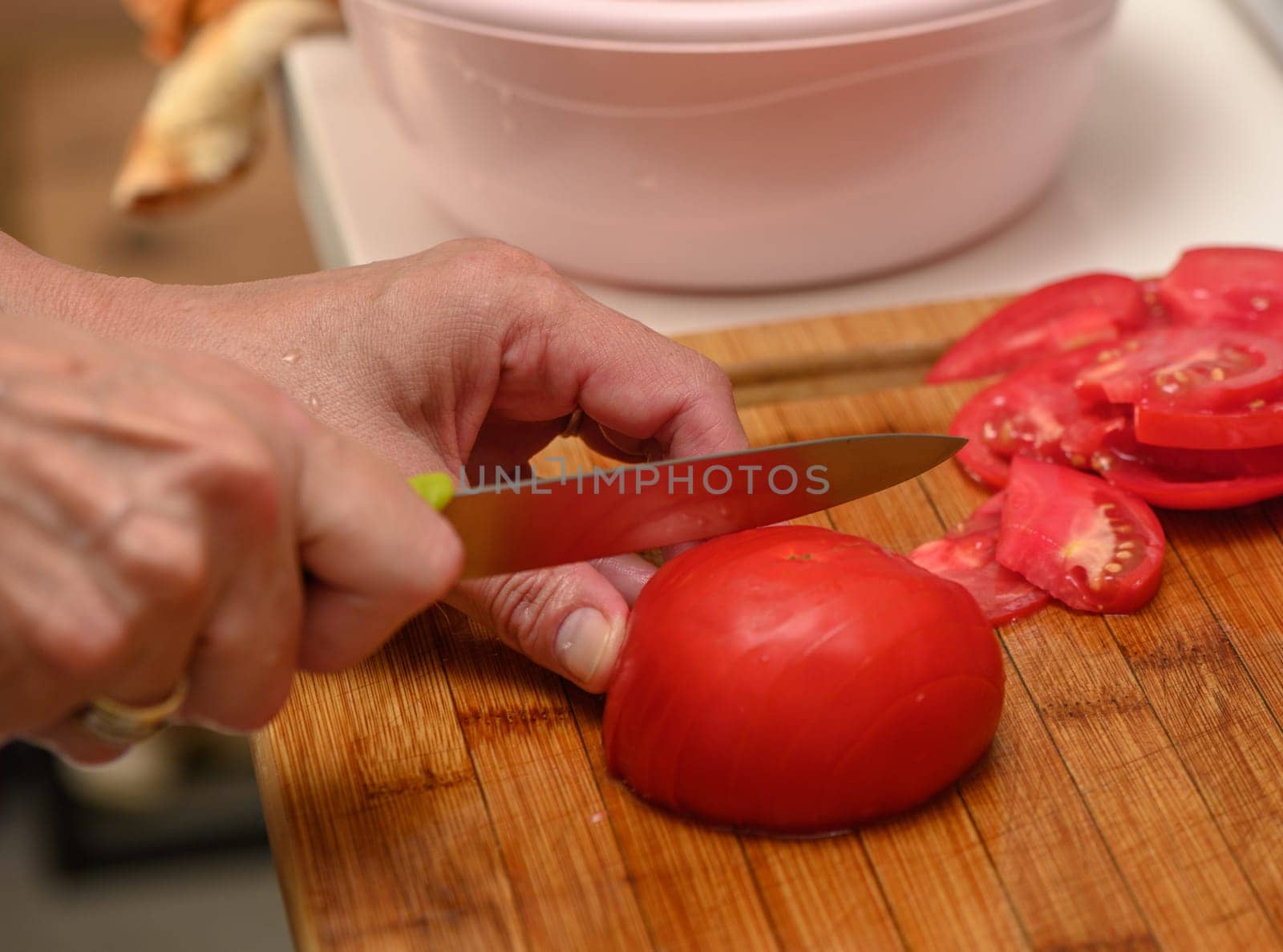 woman cutting tomato on kitchen board 5