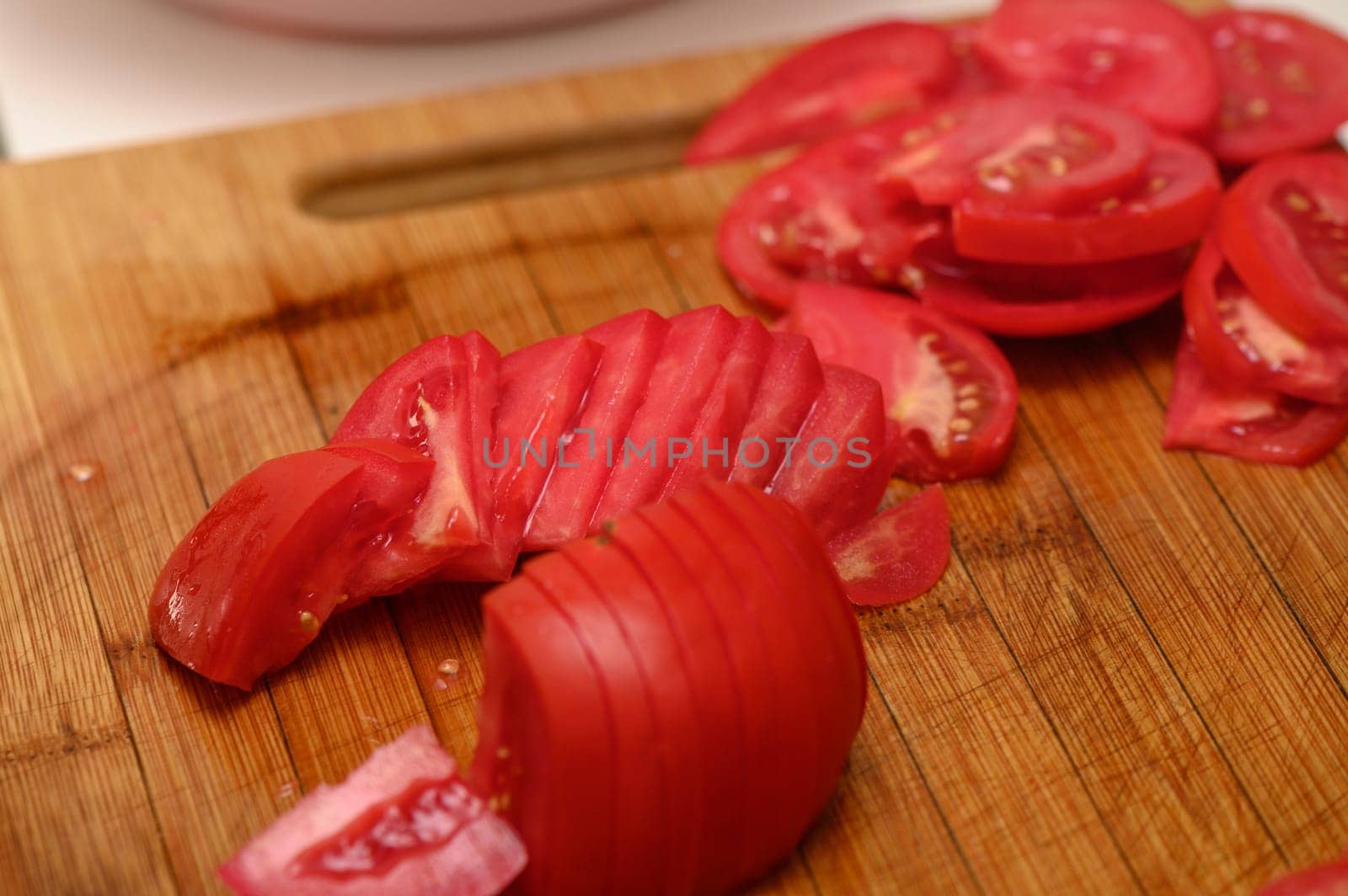 woman cutting tomato on kitchen board 7