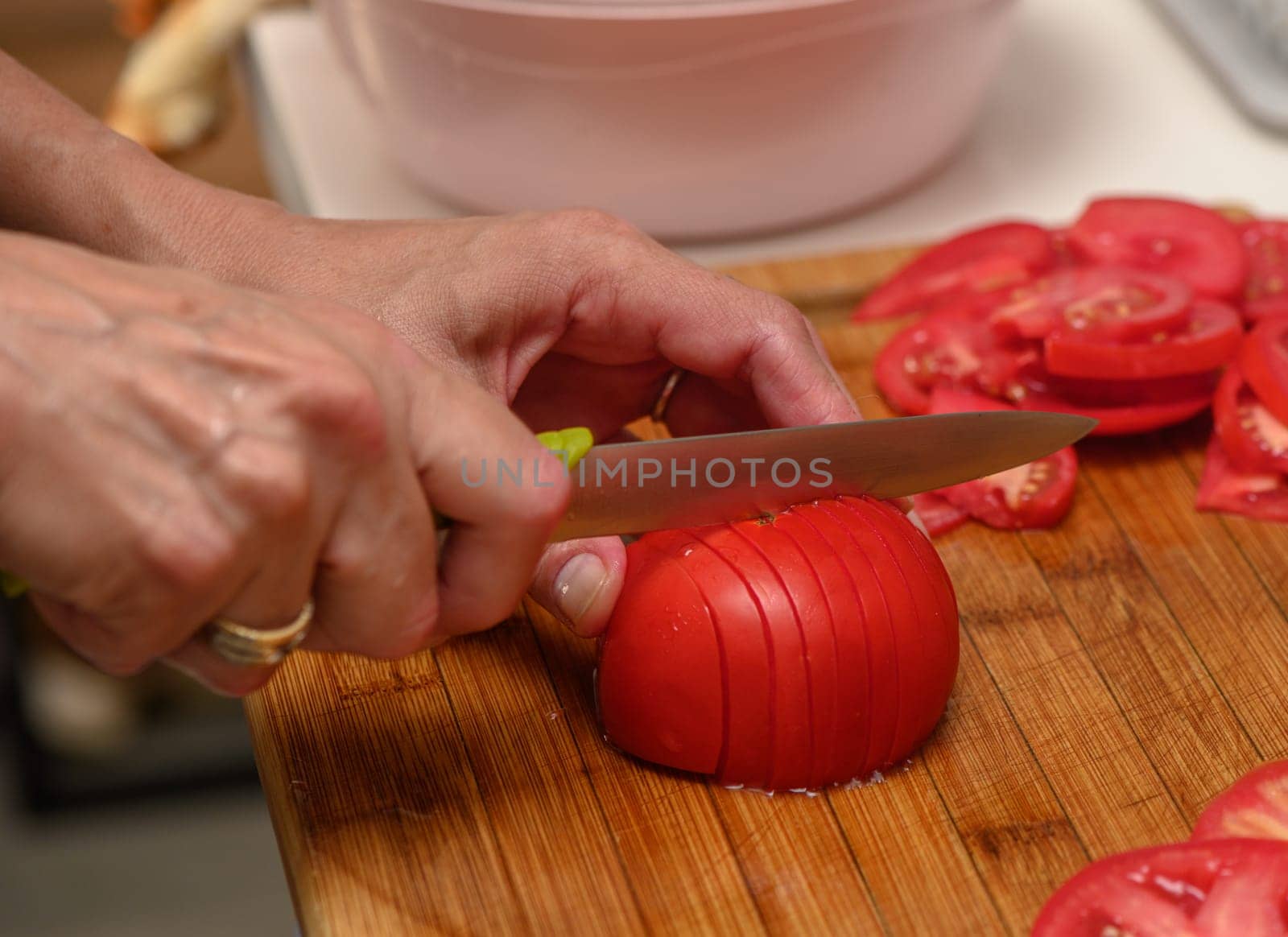 woman cutting tomato on kitchen board 6