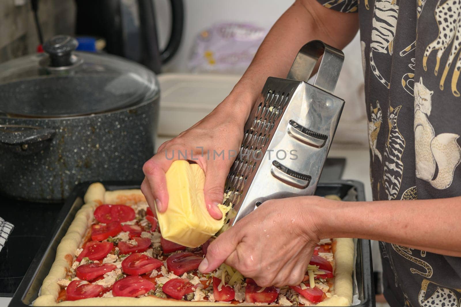 woman prepares pizza with cheese, tomatoes and chicken ham, woman rubs cheese 1 by Mixa74