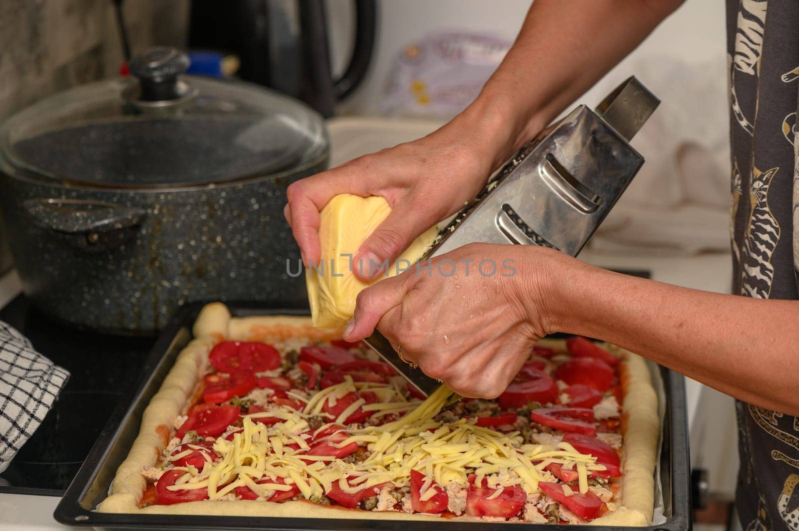 woman prepares pizza with cheese, tomatoes and chicken ham, woman rubs cheese 4 by Mixa74