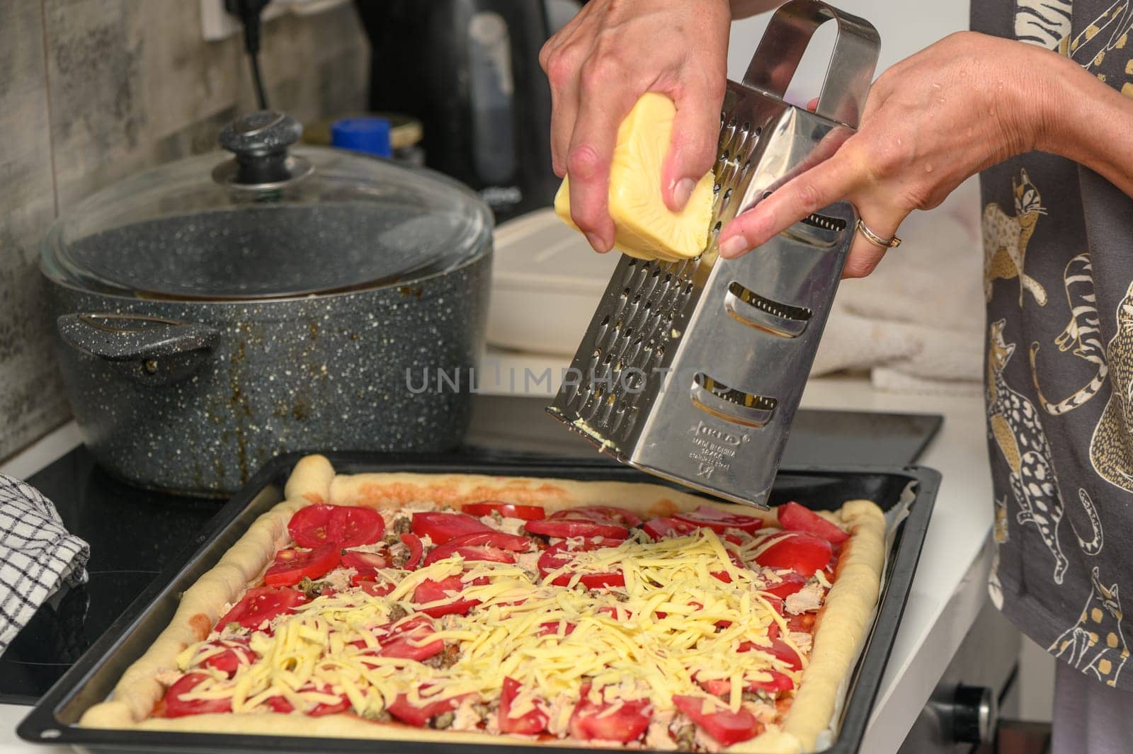 woman prepares pizza with cheese, tomatoes and chicken ham, woman rubs cheese 6 by Mixa74