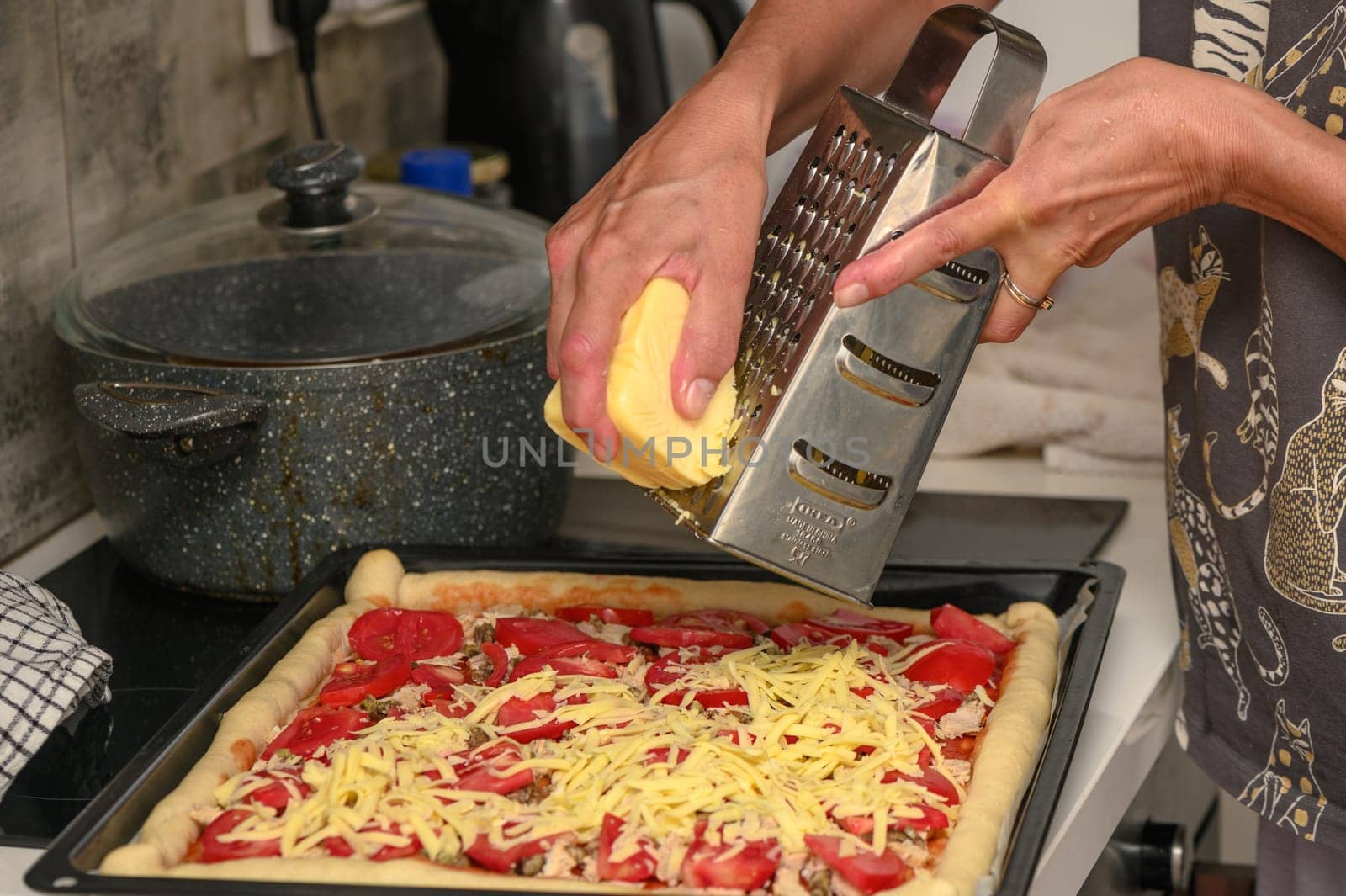 woman prepares pizza with cheese, tomatoes and chicken ham, woman rubs cheese 7 by Mixa74