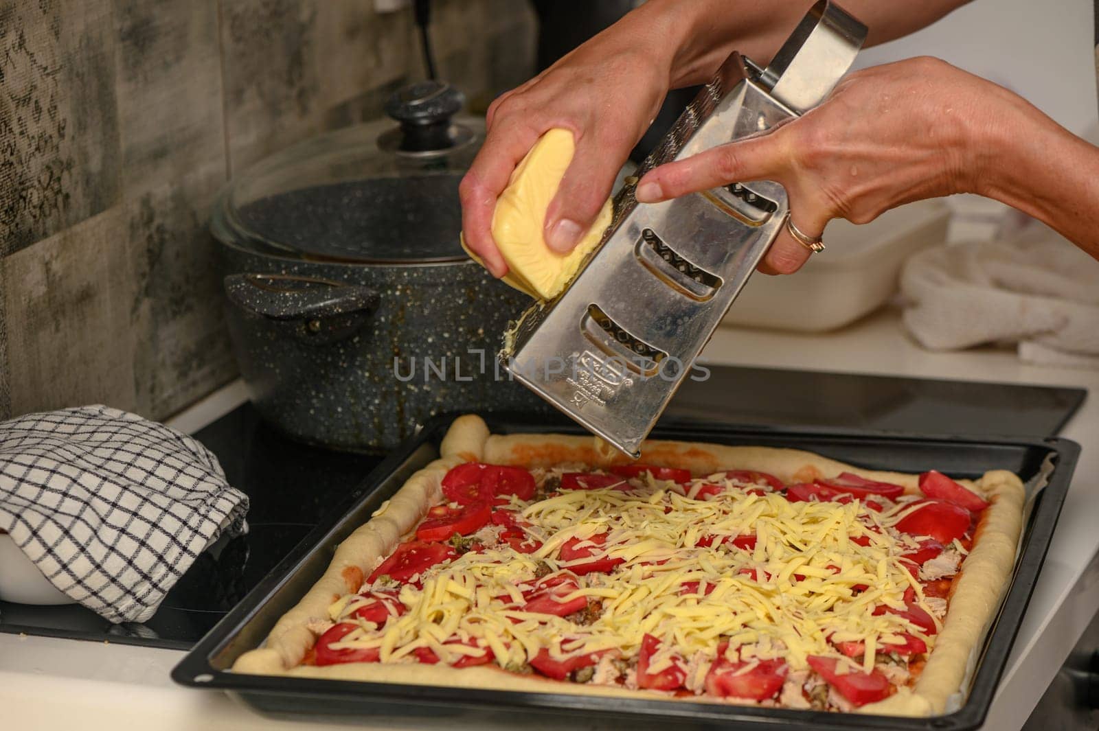 woman prepares pizza with cheese, tomatoes and chicken ham, woman rubs cheese 8 by Mixa74