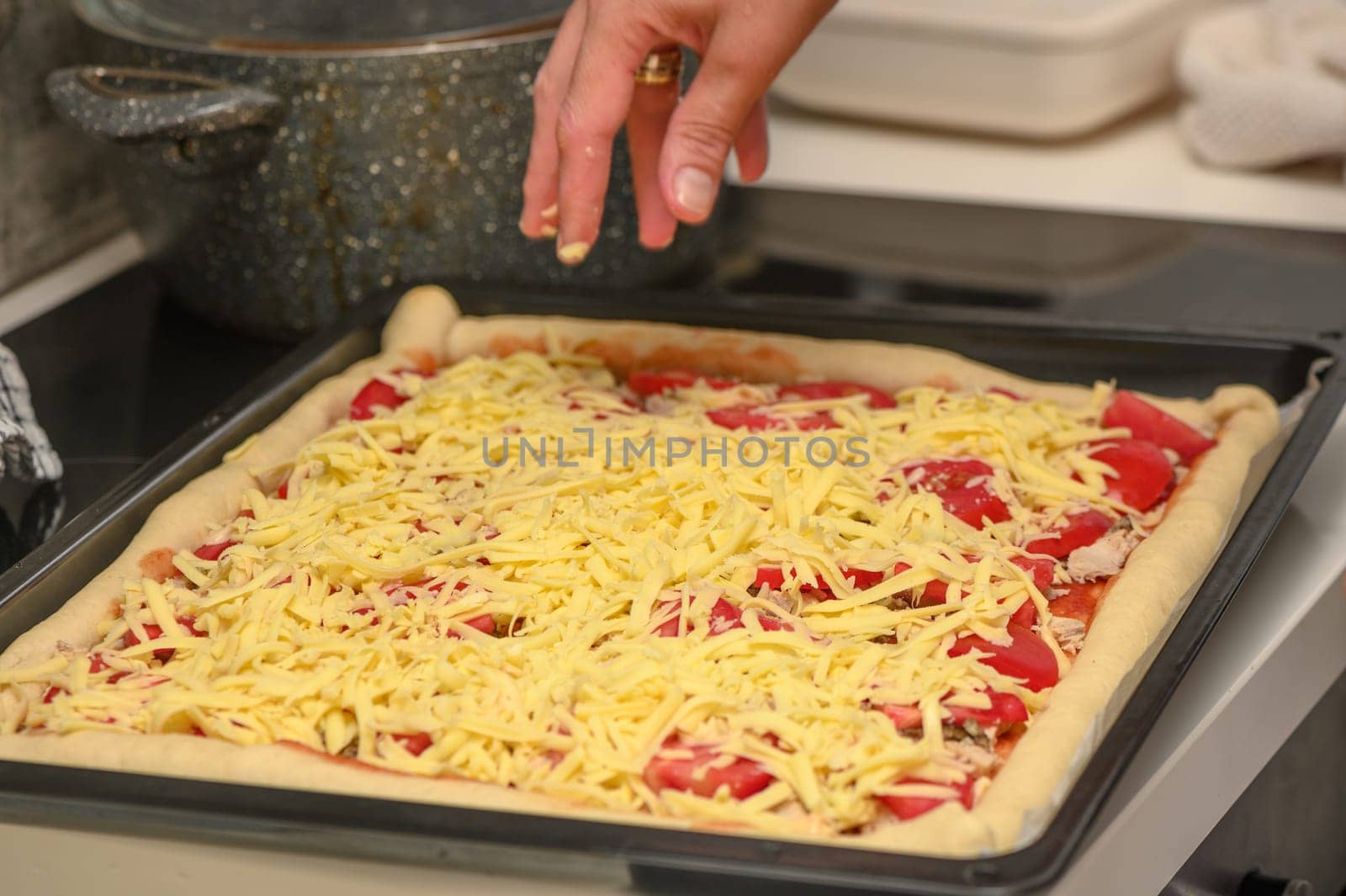 woman prepares pizza with cheese, tomatoes and chicken ham, woman rubs cheese 16 by Mixa74