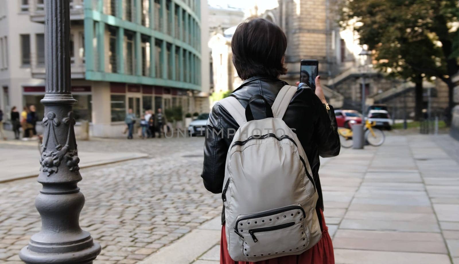 Beautiful Woman With Backpack Strolls On Street by GekaSkr