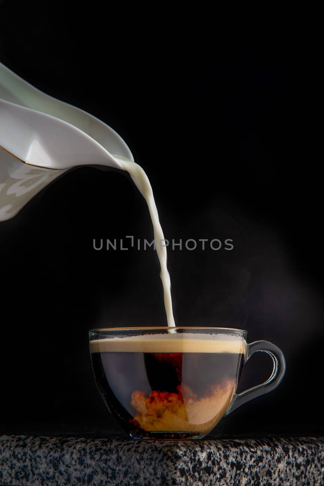 hot aromatic coffee with milk poured into it