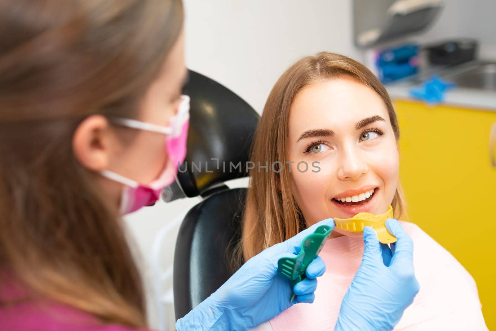 Dentist picks out plastic molds to create dental impressions to make orthodontic alignments by vladimka