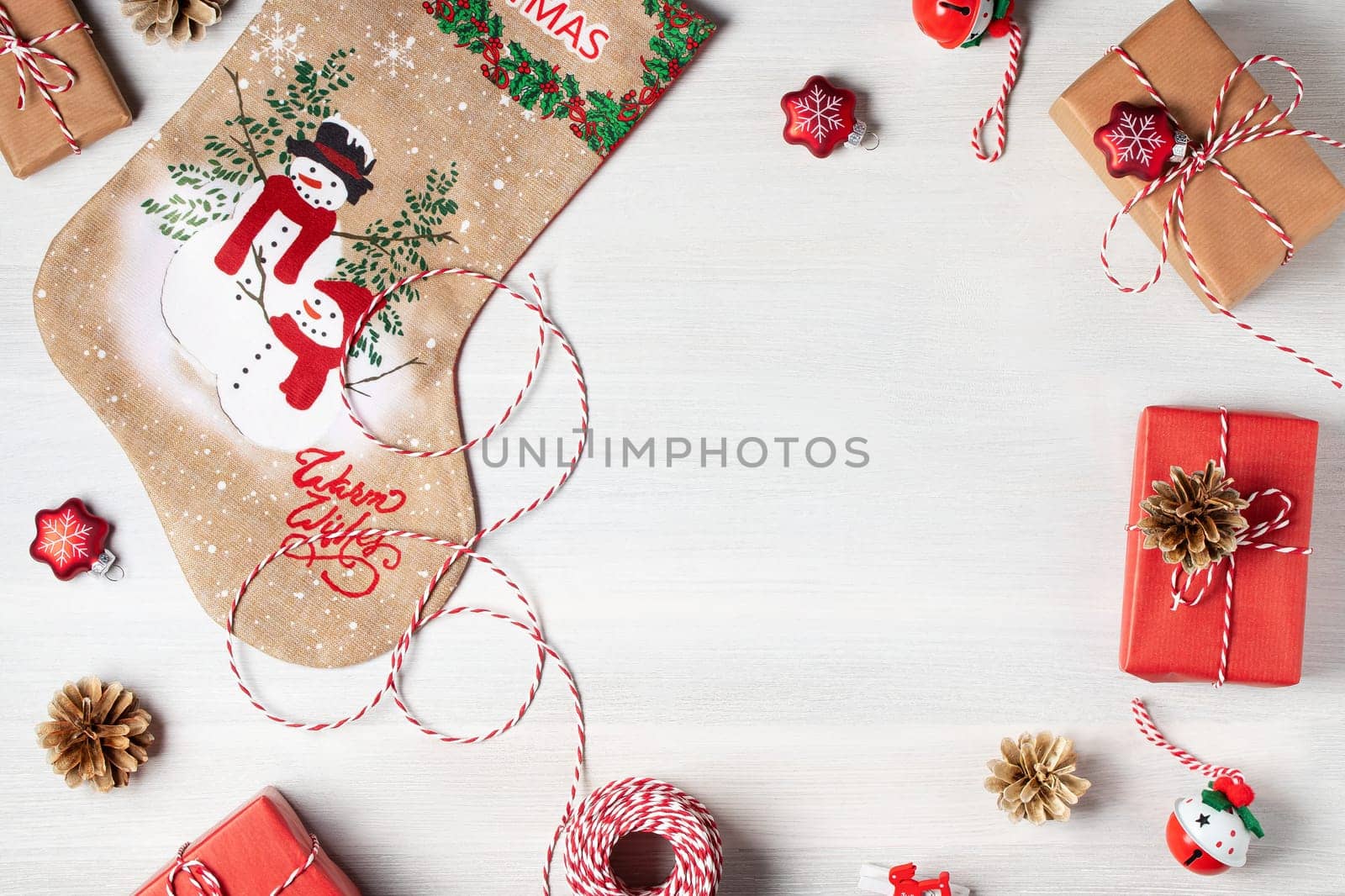 Preparing for Christmas - presents and decorations on a white wooden table. Mockup for advertisements and Christmas cards.