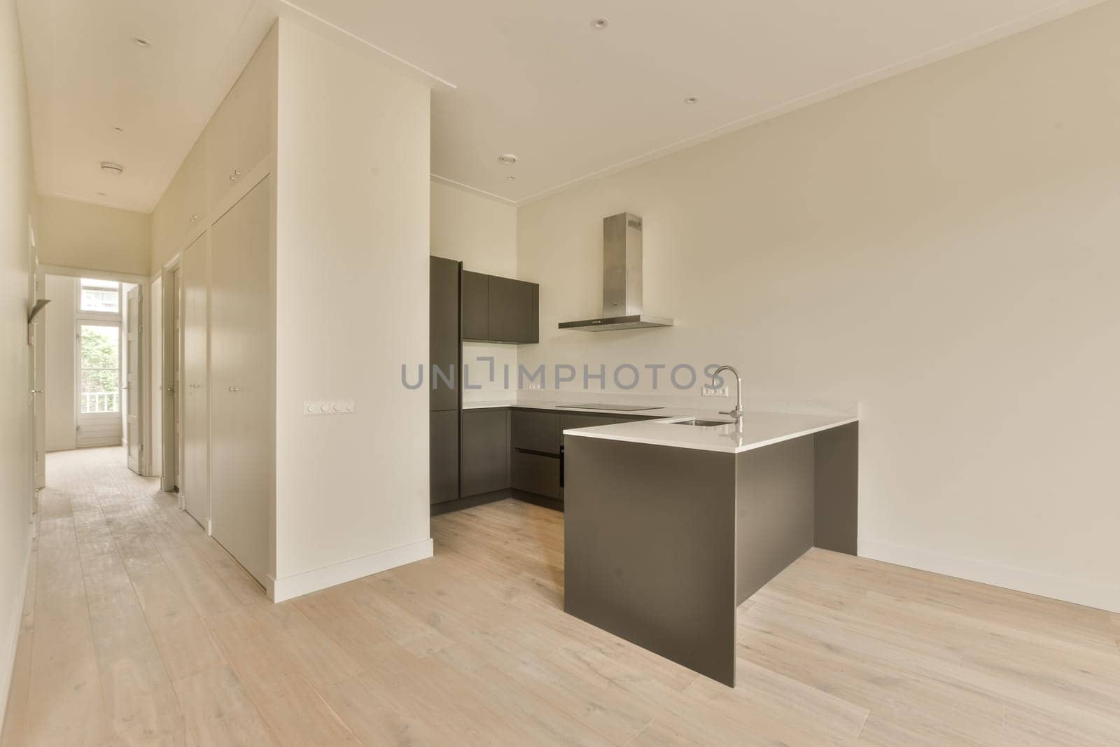 a renovated kitchen with a black island and black cabinets by casamedia