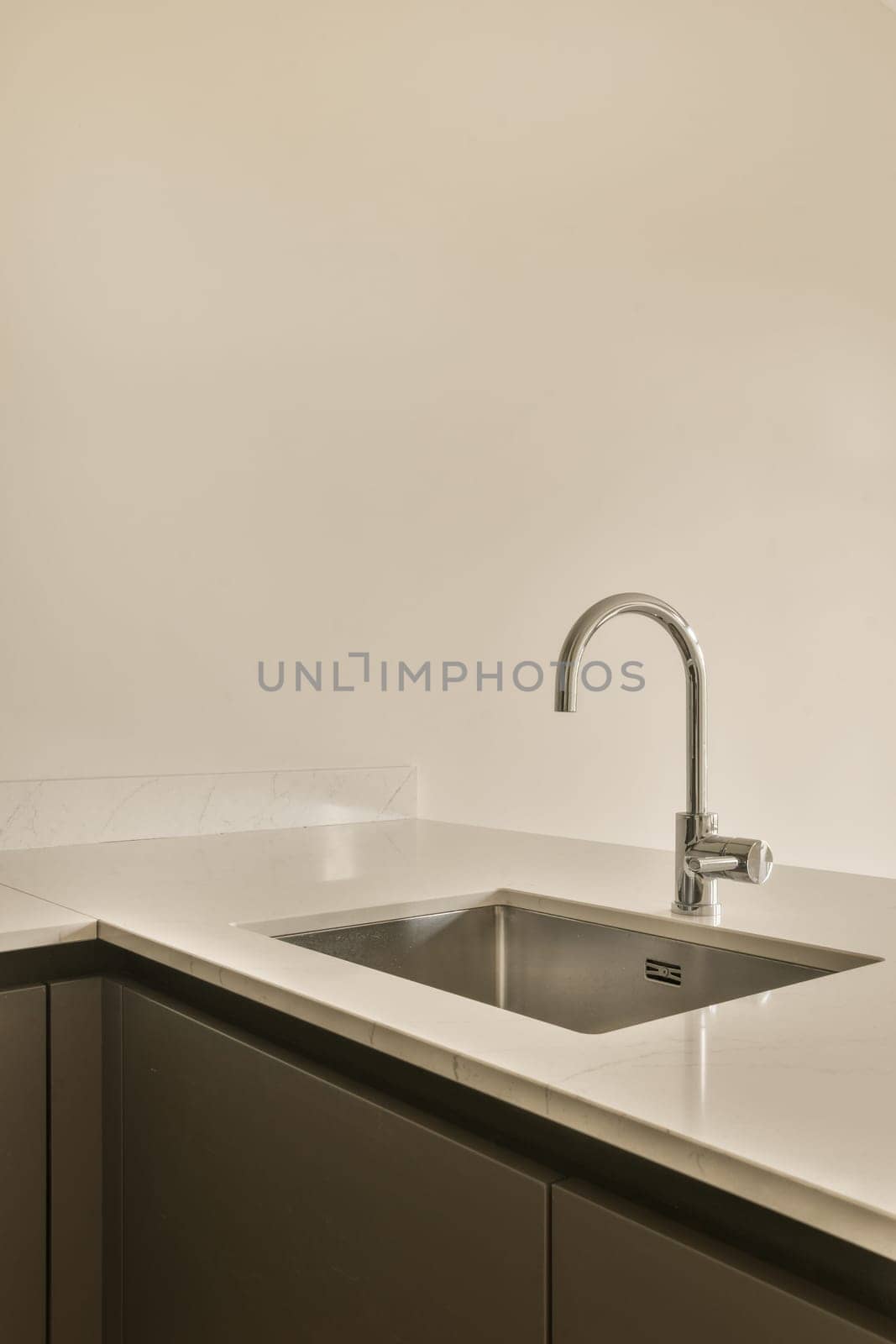 a kitchen with a sink and a faucet by casamedia