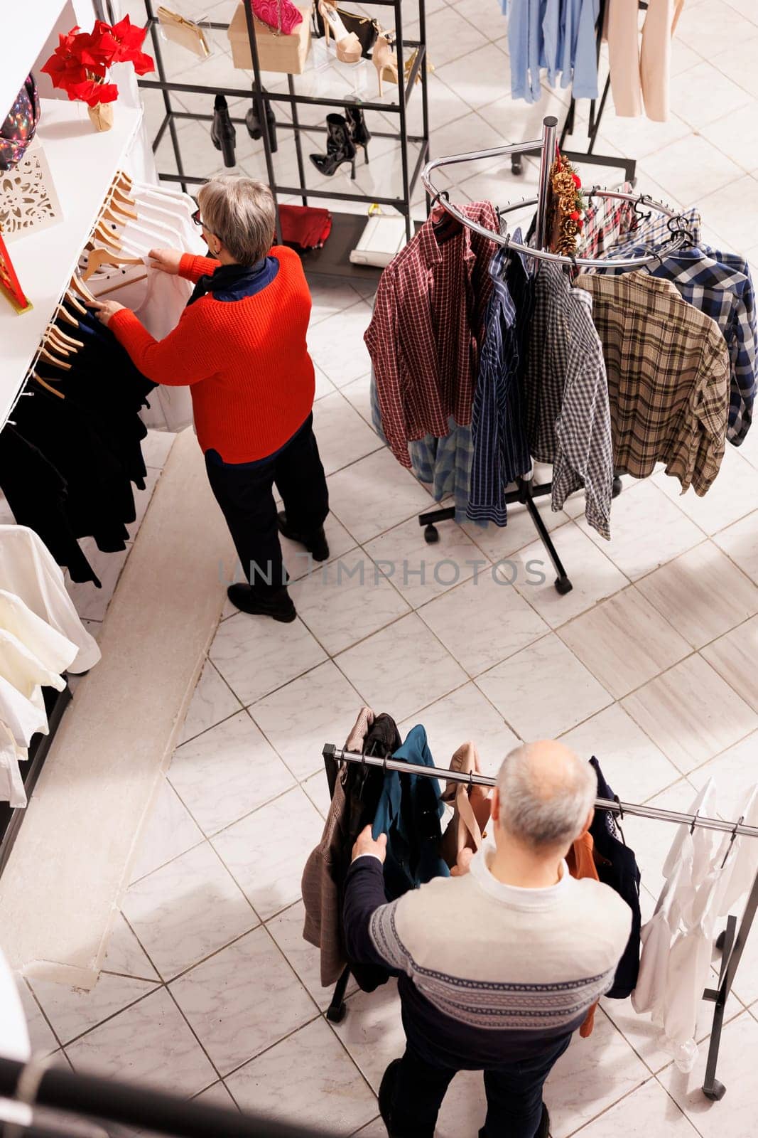 Senior people browsing for clothes by DCStudio