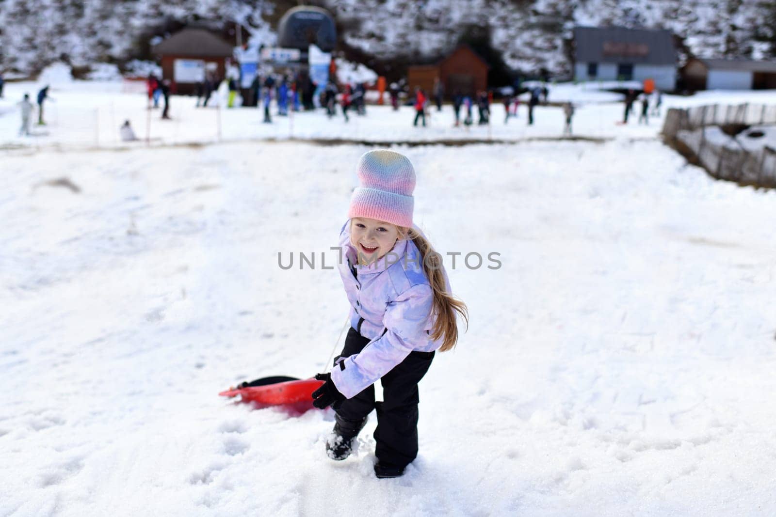 A girl with bob sledding in the snow