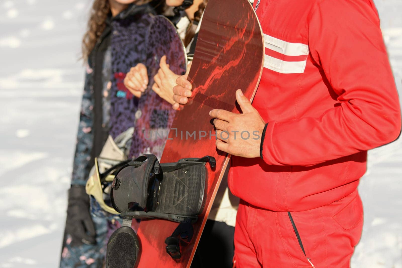 Snowboarder holding a snowboard in hands